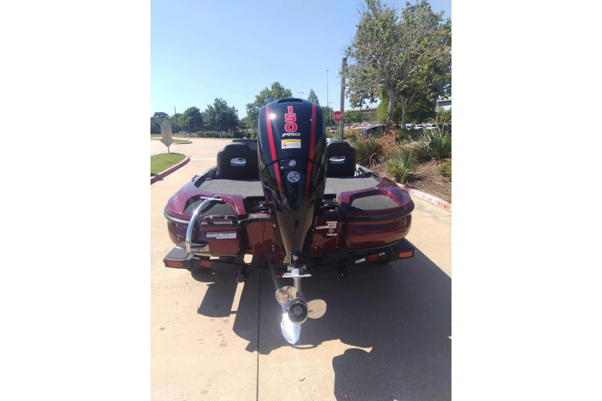 2026 Nitro Z18 boat with 150 HP engine, parked outdoors on a sunny day.