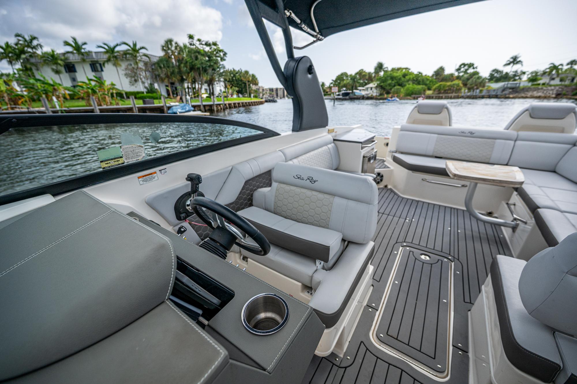 2022 Sea Ray SDX 290 boat interior with luxurious seating and sleek design on a sunny day.