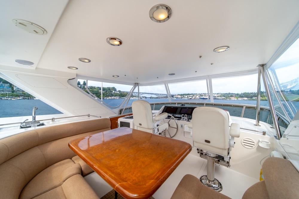 Luxurious 2005 Ocean Alexander 64 Motoryacht helm with panoramic views and elegant seating.