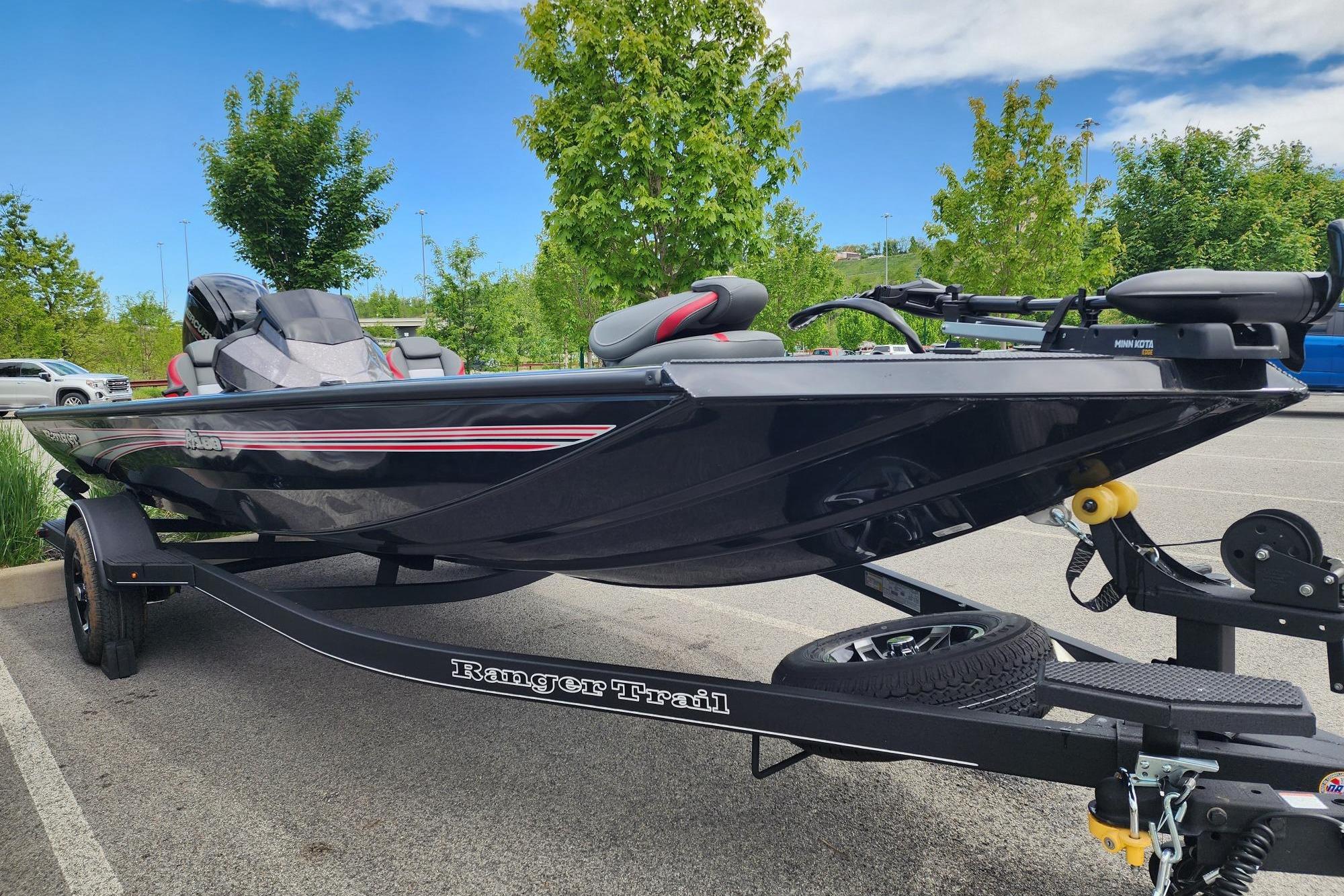 2026 Ranger RT188 boat on trailer in parking lot, surrounded by trees.