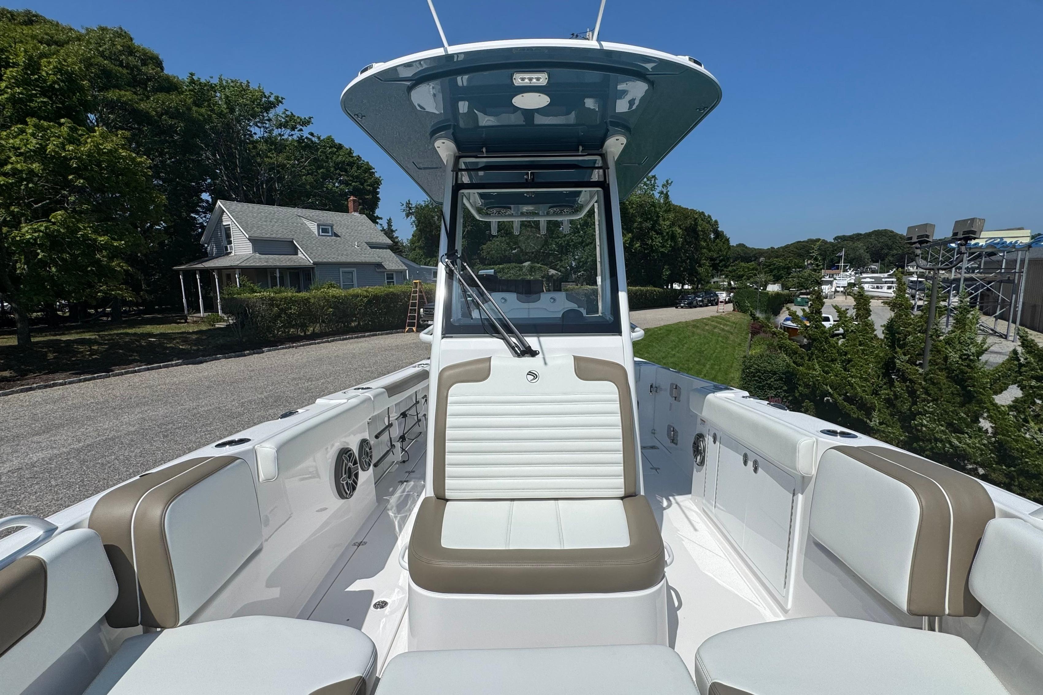 2026 Edgewater 250CC boat interior with seating, console, and clear blue sky background.