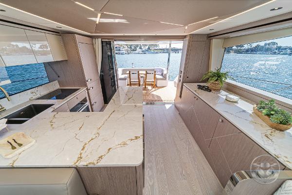 Luxurious interior of 2025 Sunseeker Manhattan 68 yacht with modern kitchen and scenic views.