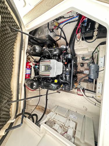 Engine compartment of a 2015 Sea Ray 260 Sundancer boat, showcasing mechanical components.