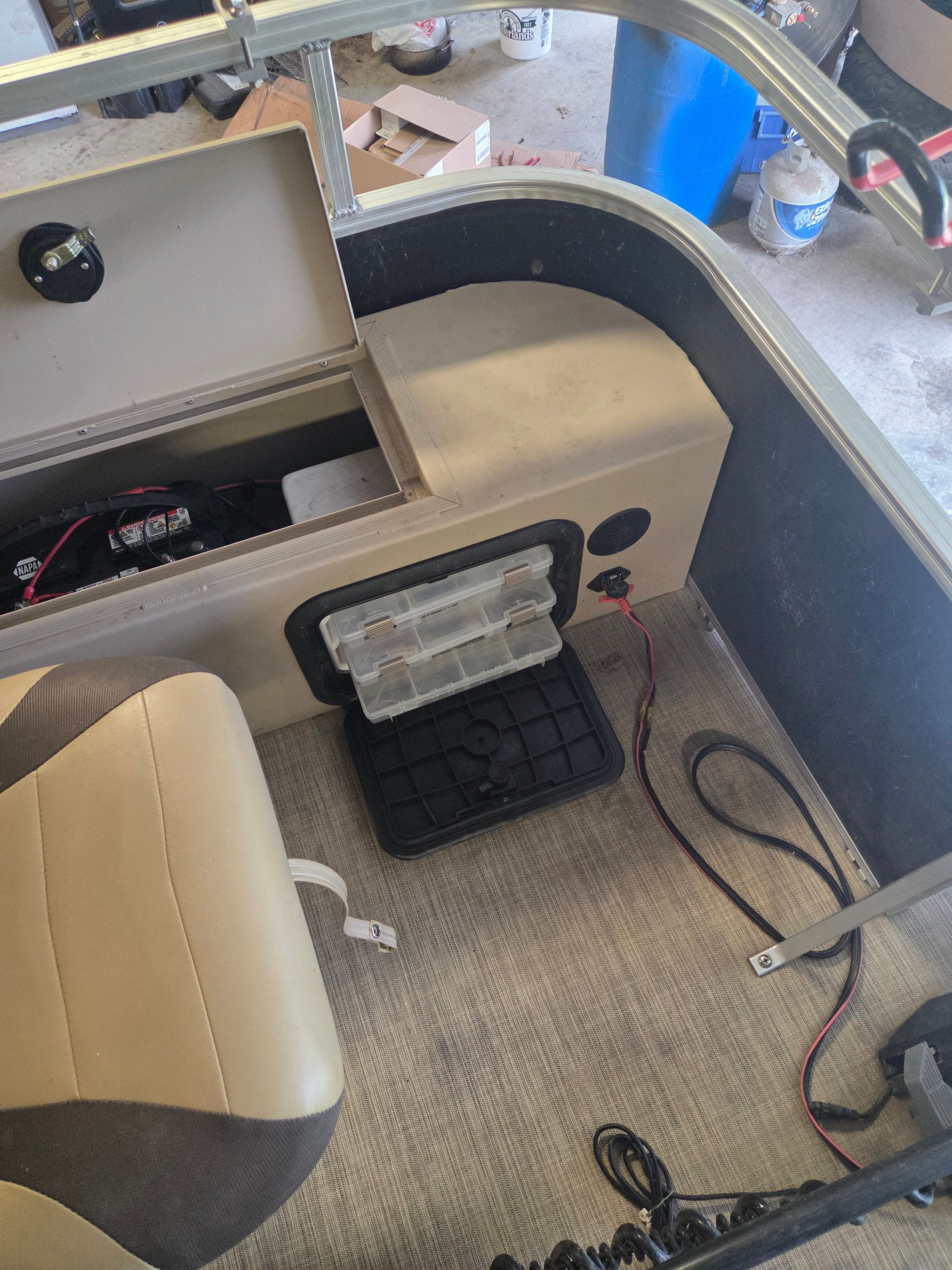 Interior of a boat with seating and storage area.