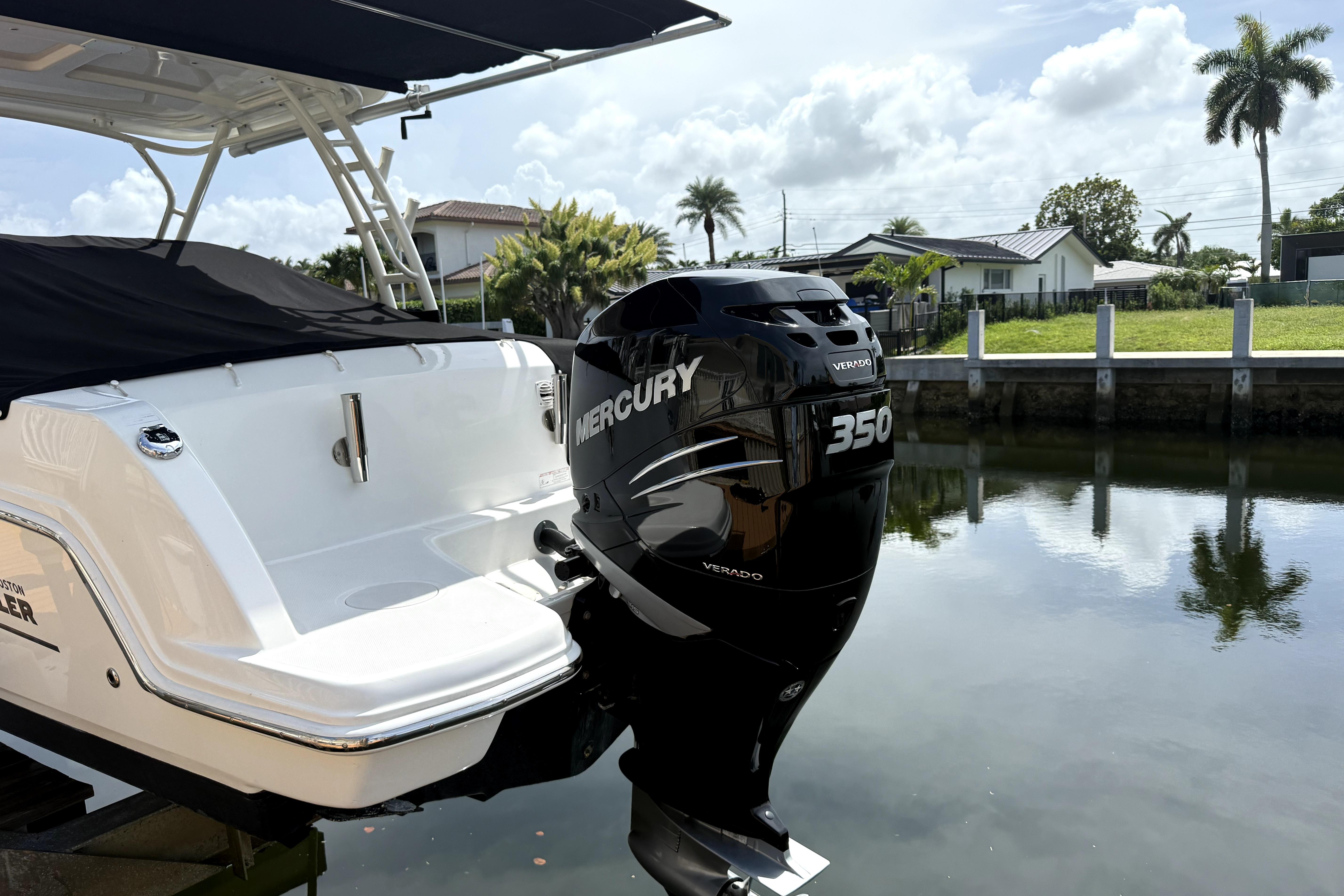 2018 Boston Whaler 230 Vantage with Mercury 350 Verado engine docked by a canal.