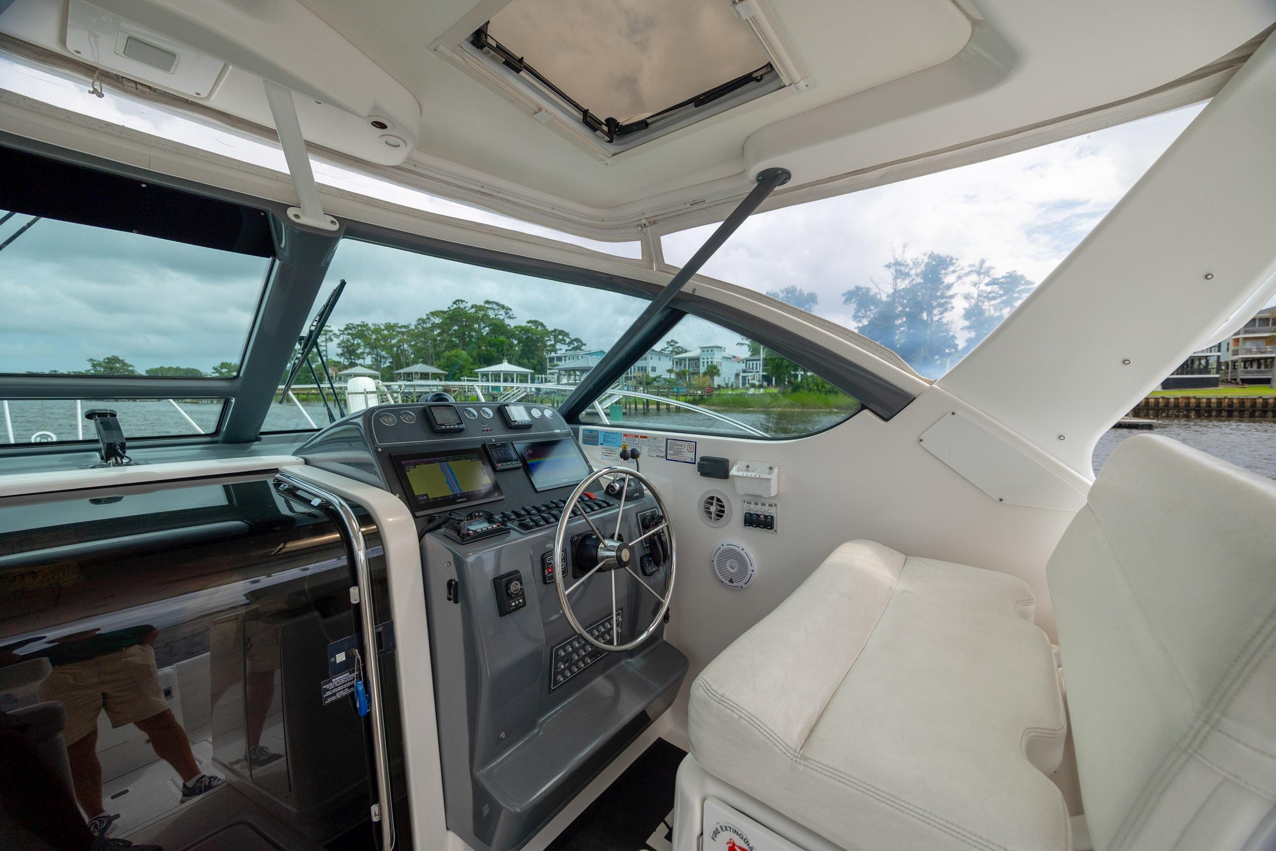 2004 Tiara Yachts 3200 Open helm with navigation equipment and white seating.