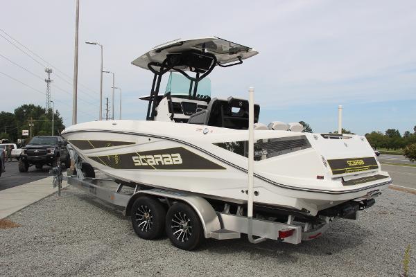 2023 Scarab 255 Open ID boat on trailer, parked outdoors.