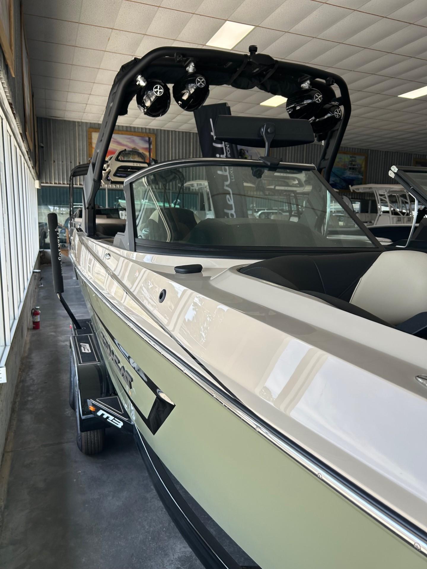 2024 MB F22 Tomcat boat in showroom, featuring sleek design and advanced audio system.