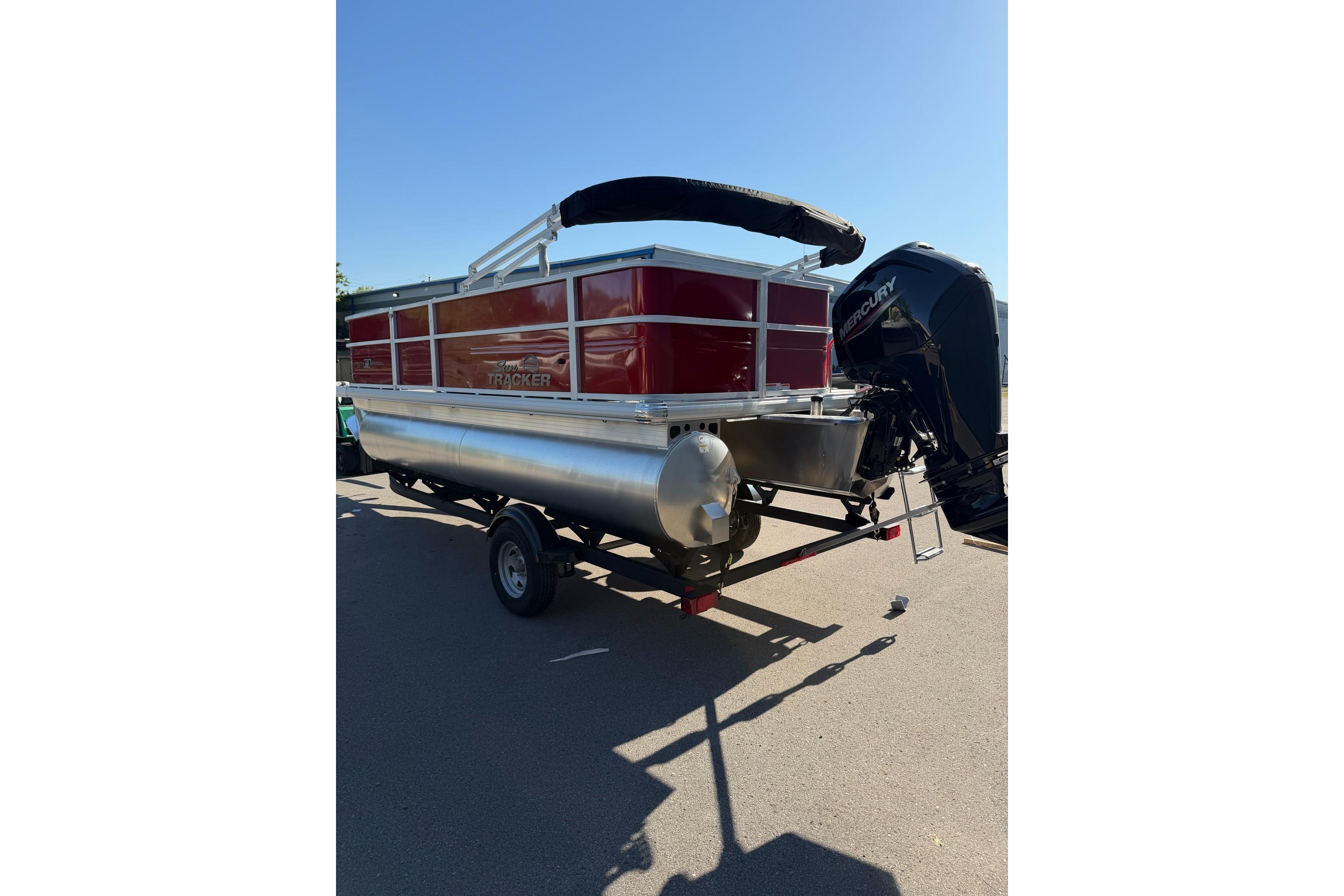 2026 Sun Tracker Party Barge 18 DLX pontoon boat with Mercury outboard engine.