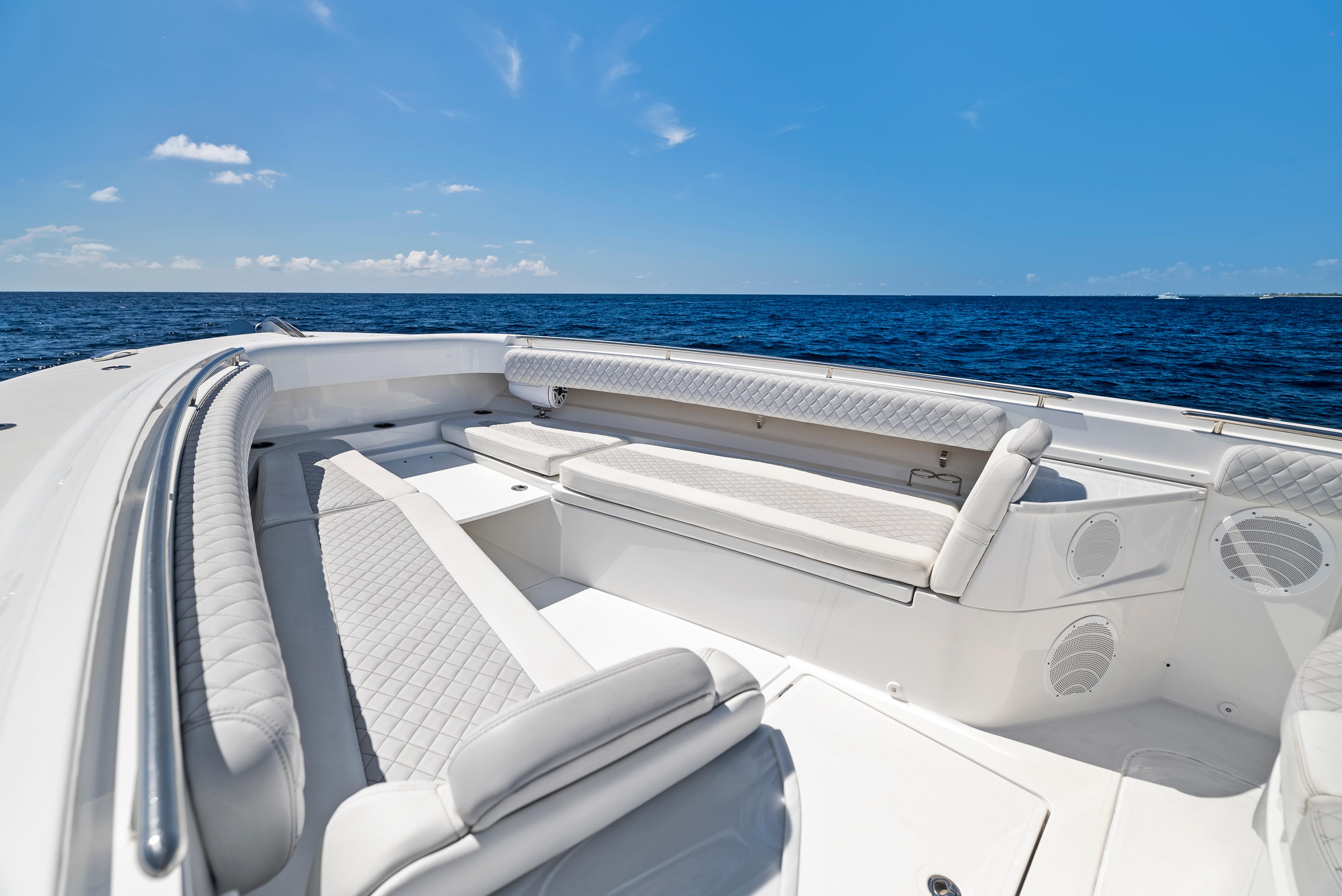 2022 HCB Suenos boat interior with luxurious seating, ocean view, and clear blue sky.