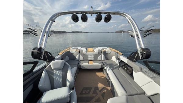 2023 MasterCraft XT22 boat interior with luxury seating and lake view.