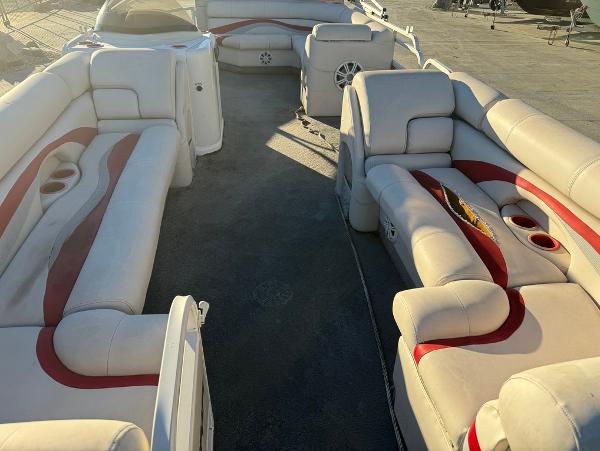 2005 Starcraft 22 Sport boat interior with beige and red seating, spacious layout.