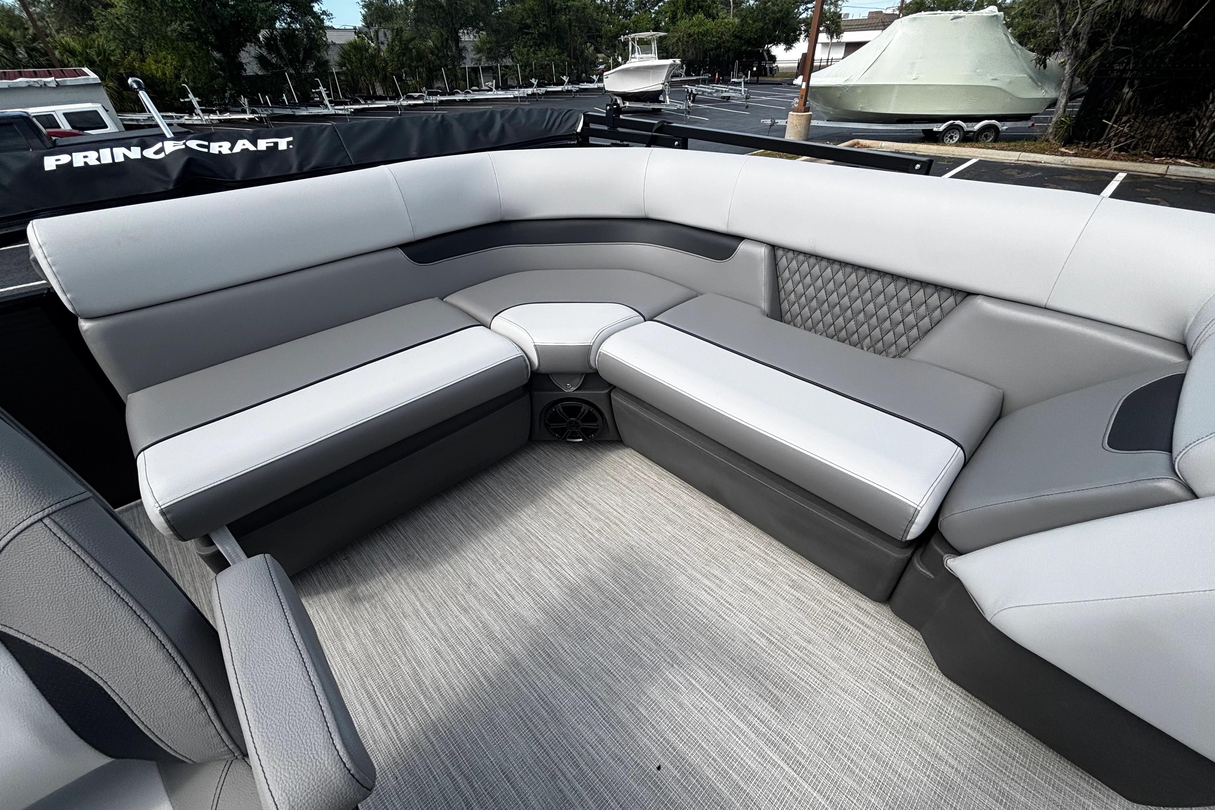 2026 Princecraft Sportfisher 21-2S boat interior with gray cushioned seating.
