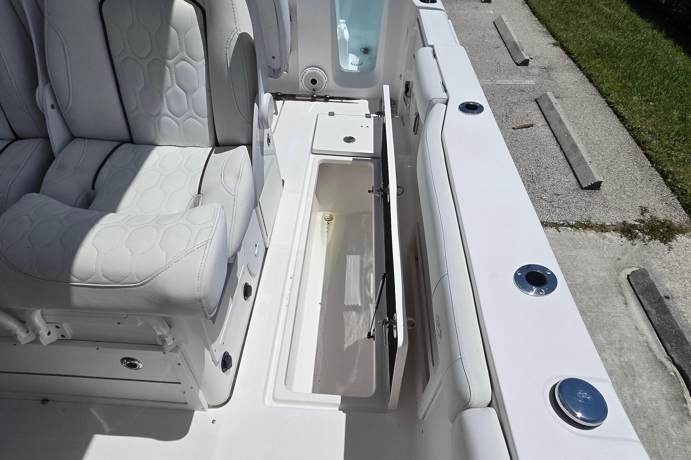 2021 Sea Fox 328 Commander boat interior with open storage compartment and cushioned seating.