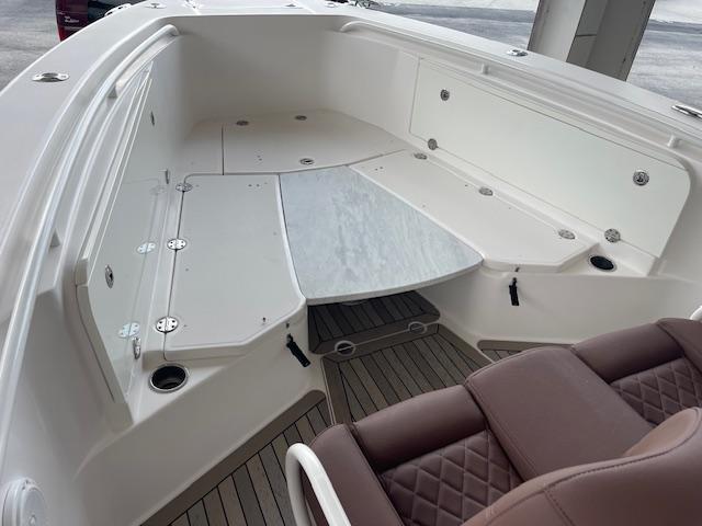 2014 Everglades 325 Center Console boat interior with seating and storage compartments.