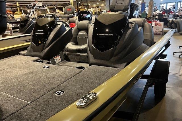 2026 Tracker Pro Team 175 boat with dual seats and sleek design in showroom.