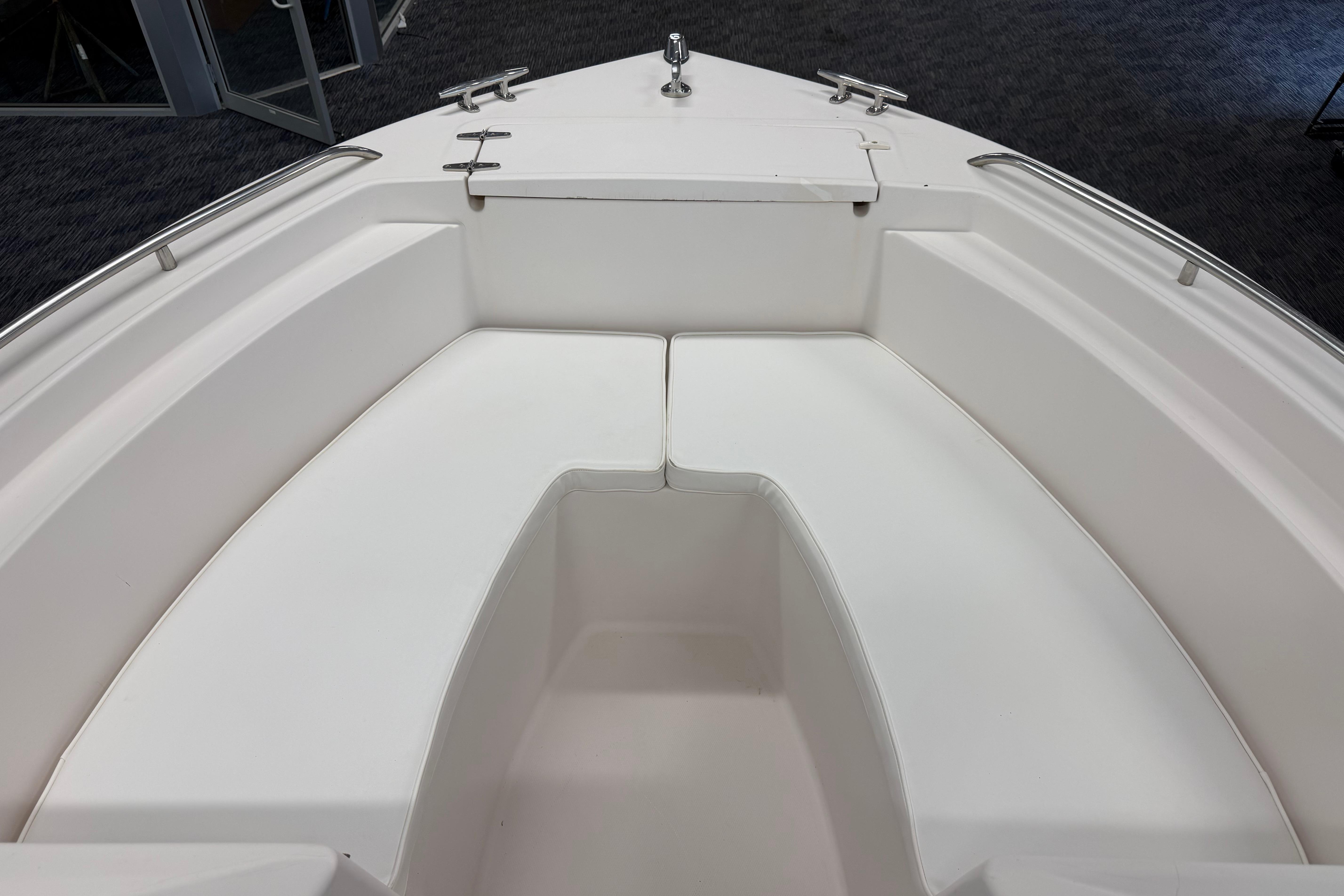 2001 Grady-White Tournament 223 boat interior with white seating and stainless steel rails.
