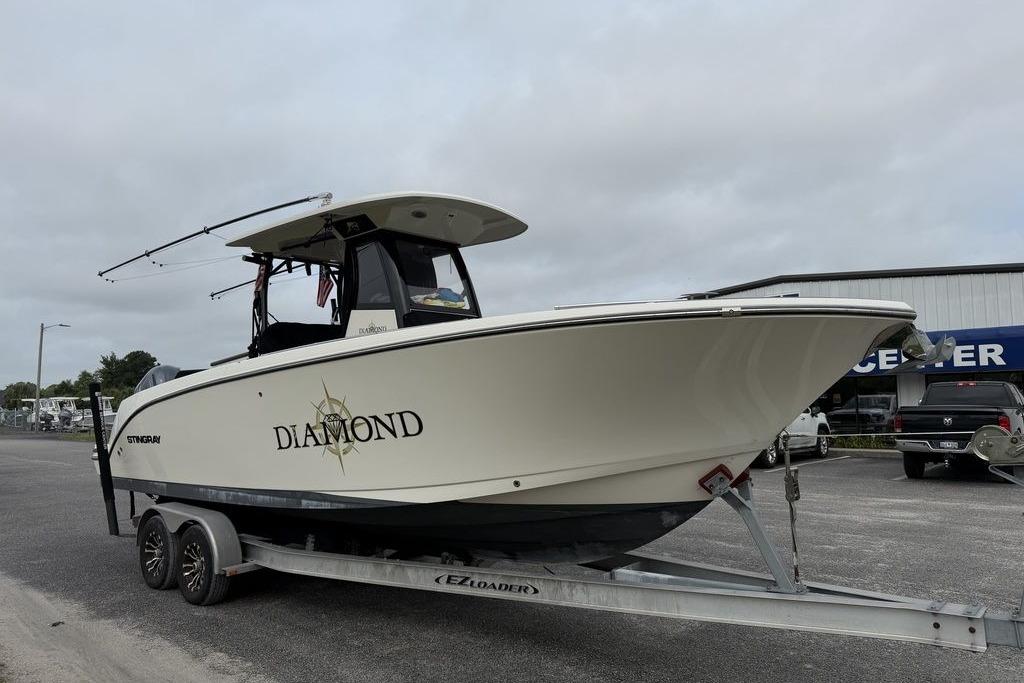2023 Stingray 273 CC boat named "Diamond" on trailer in parking lot.