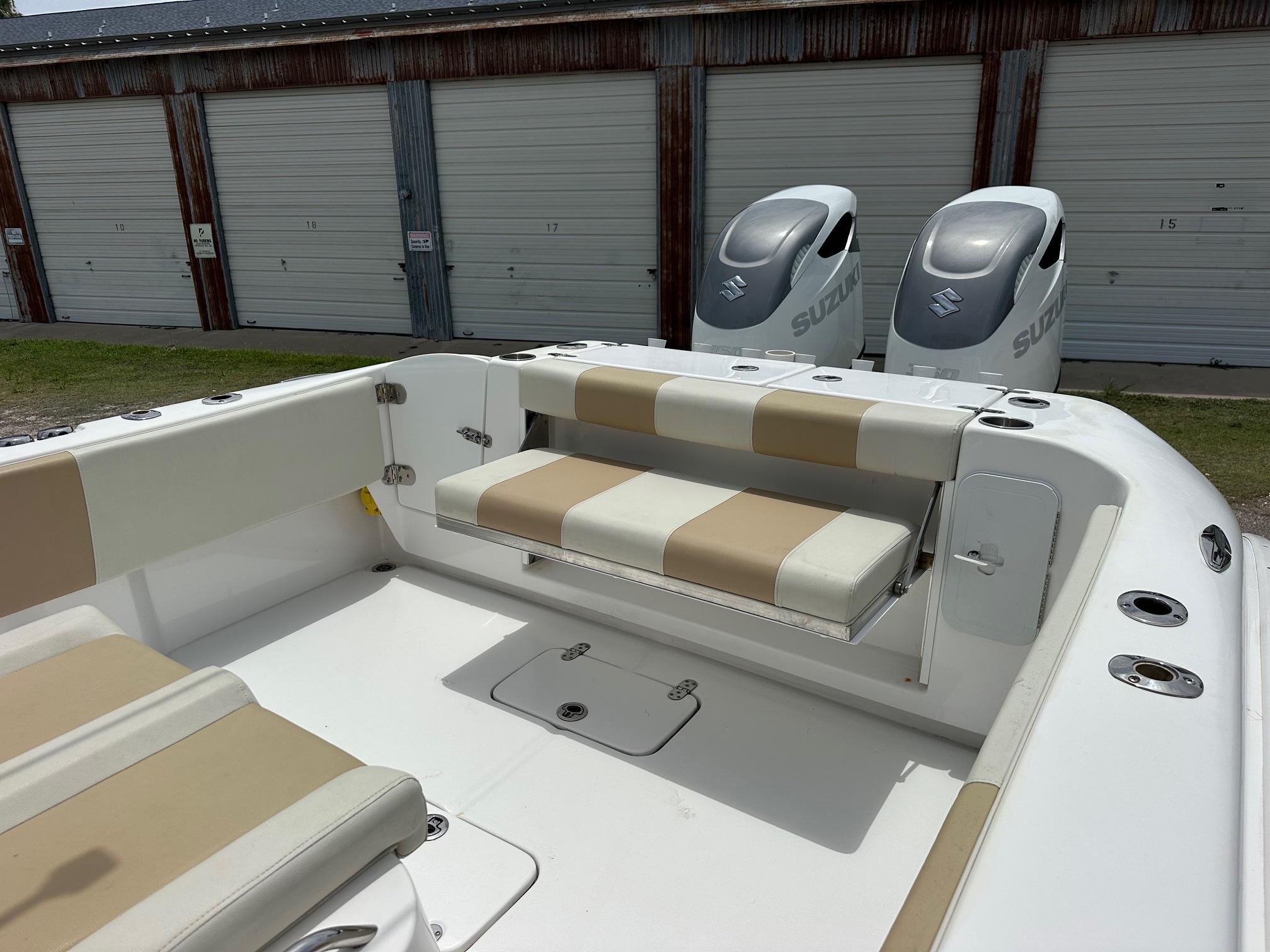 2023 Cape Horn 32xs boat interior with beige seating and dual Suzuki outboard motors.