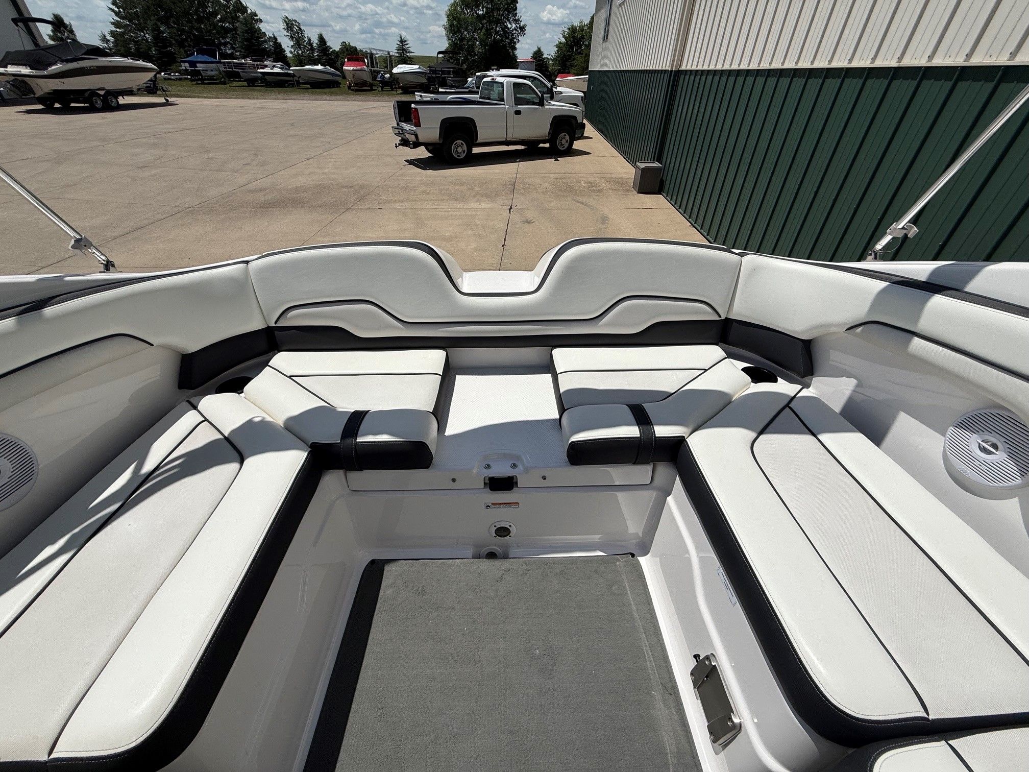 The image shows the interior of a Yamaha SX210 boat with white seating.