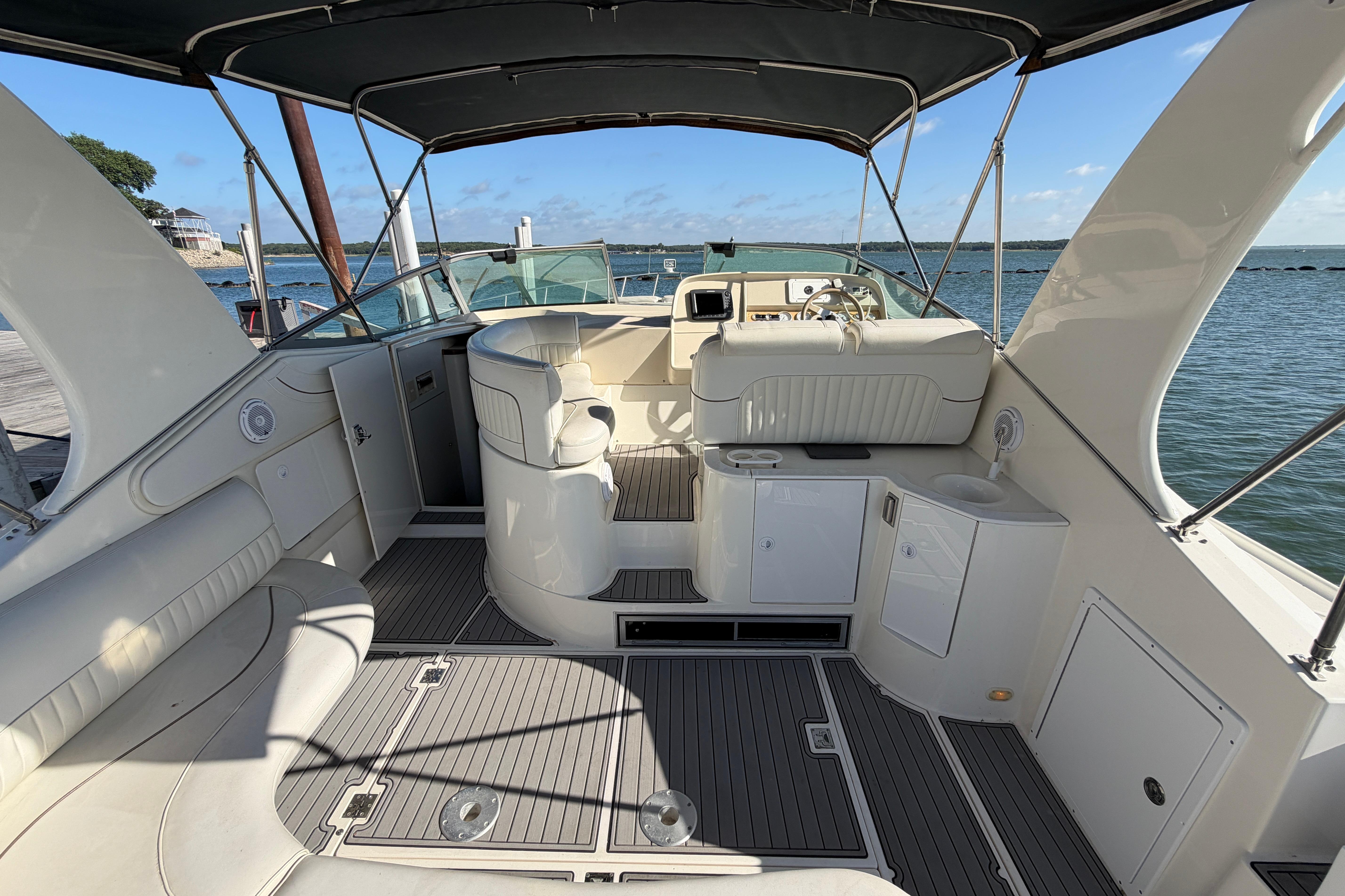 1997 Cruisers 3575 yacht interior with seating, helm, and water view.