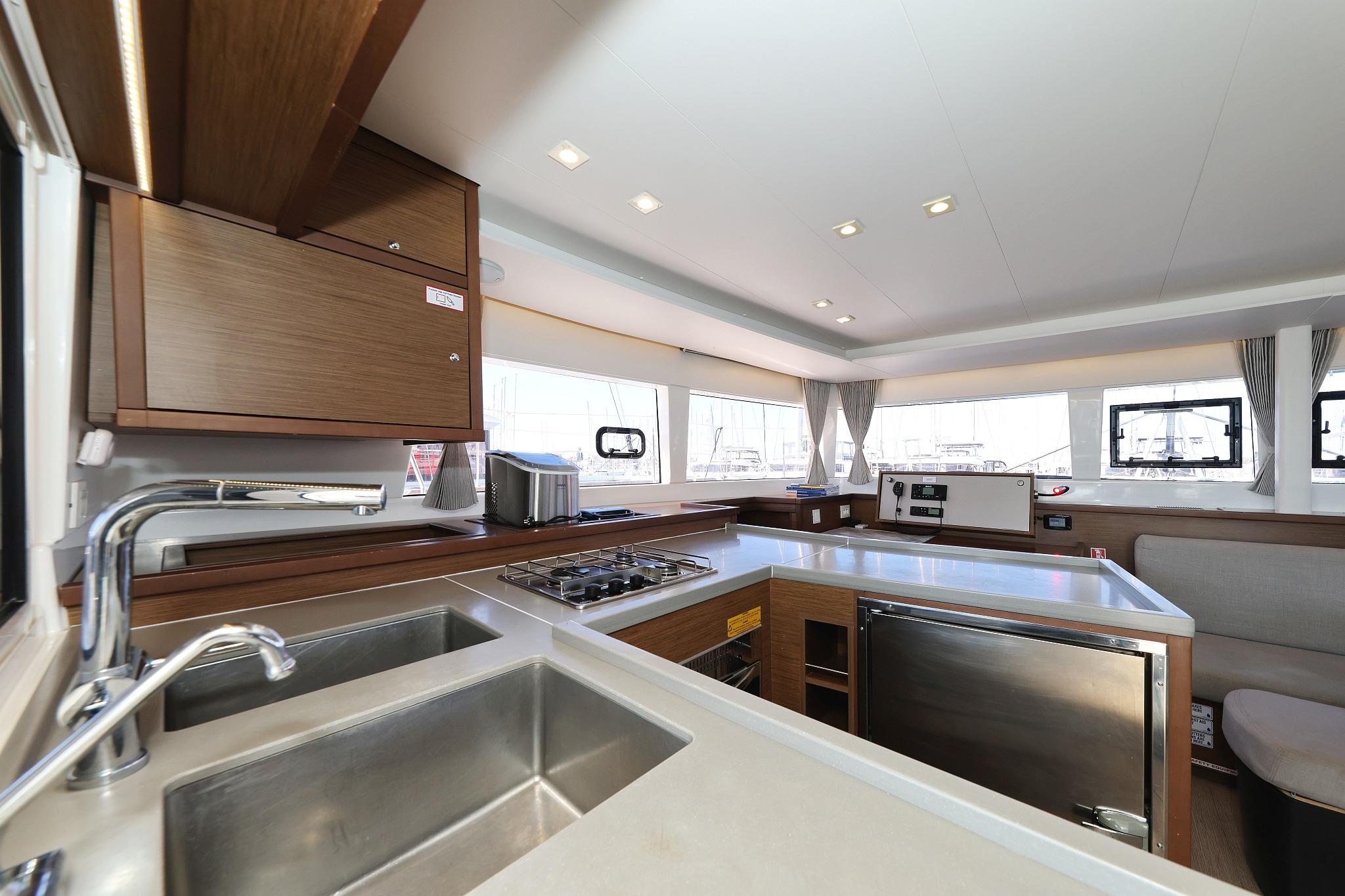 Modern kitchen interior of 2020 Lagoon 450 F yacht with sleek design and ample natural light.