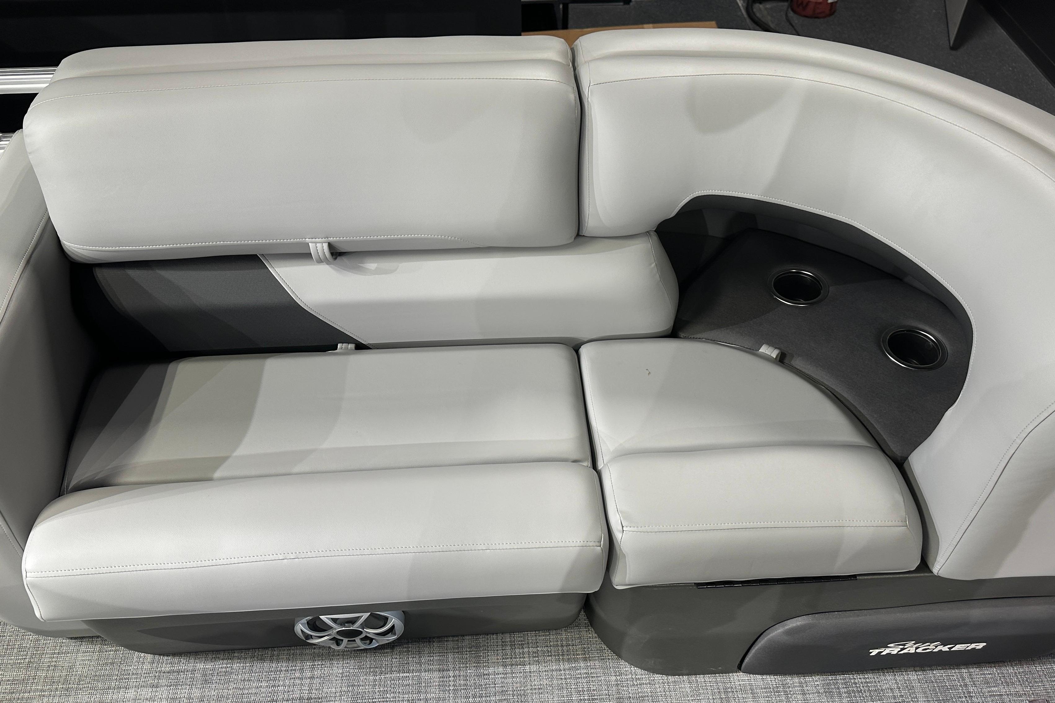 2026 Sun Tracker SportFish 22 DLX boat seating with cup holders and speaker.