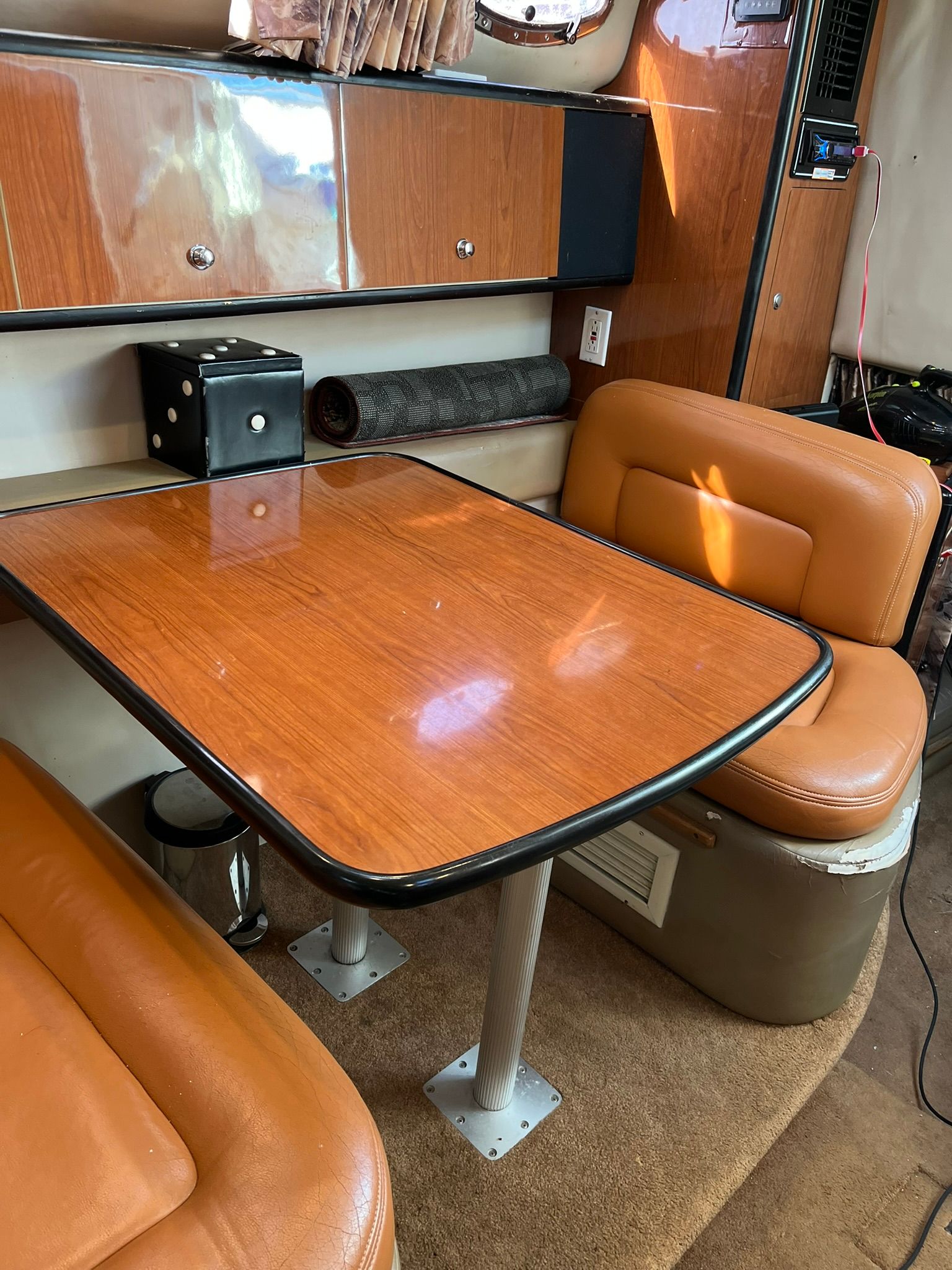 Interior of a 2000 Chaparral Signature with wooden table and leather seats.