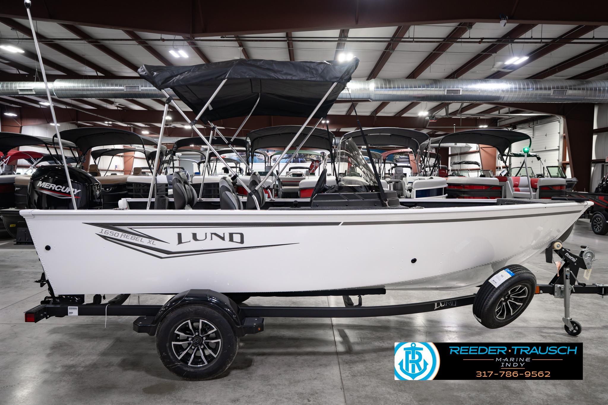 2026 Lund 1650 Rebel XL SS boat in showroom, featuring sleek design and modern features.