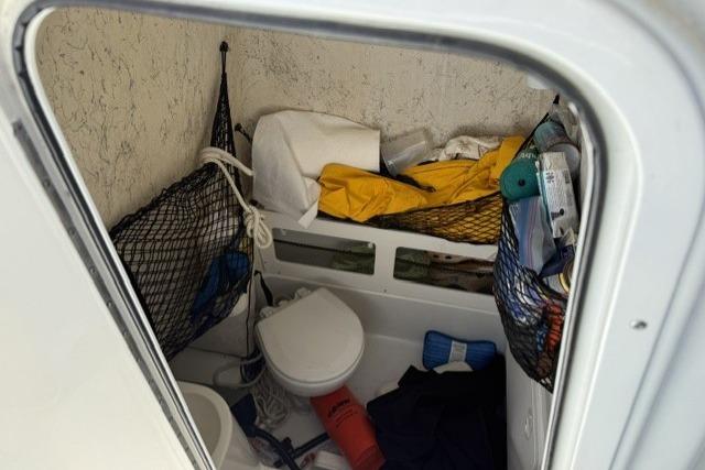 Interior of 2006 Sailfish 2660 CC boat with storage and marine toilet.