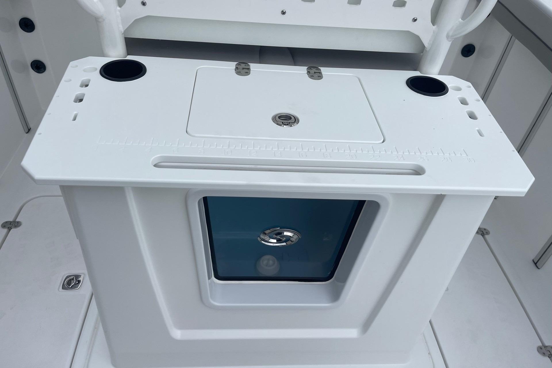 2026 Hurricane Center Console 24 OB boat interior with storage compartment and cup holders.