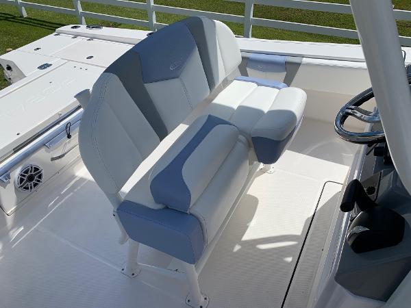 2024 Robalo 266 Cayman boat seating area with white and gray cushioned seats.