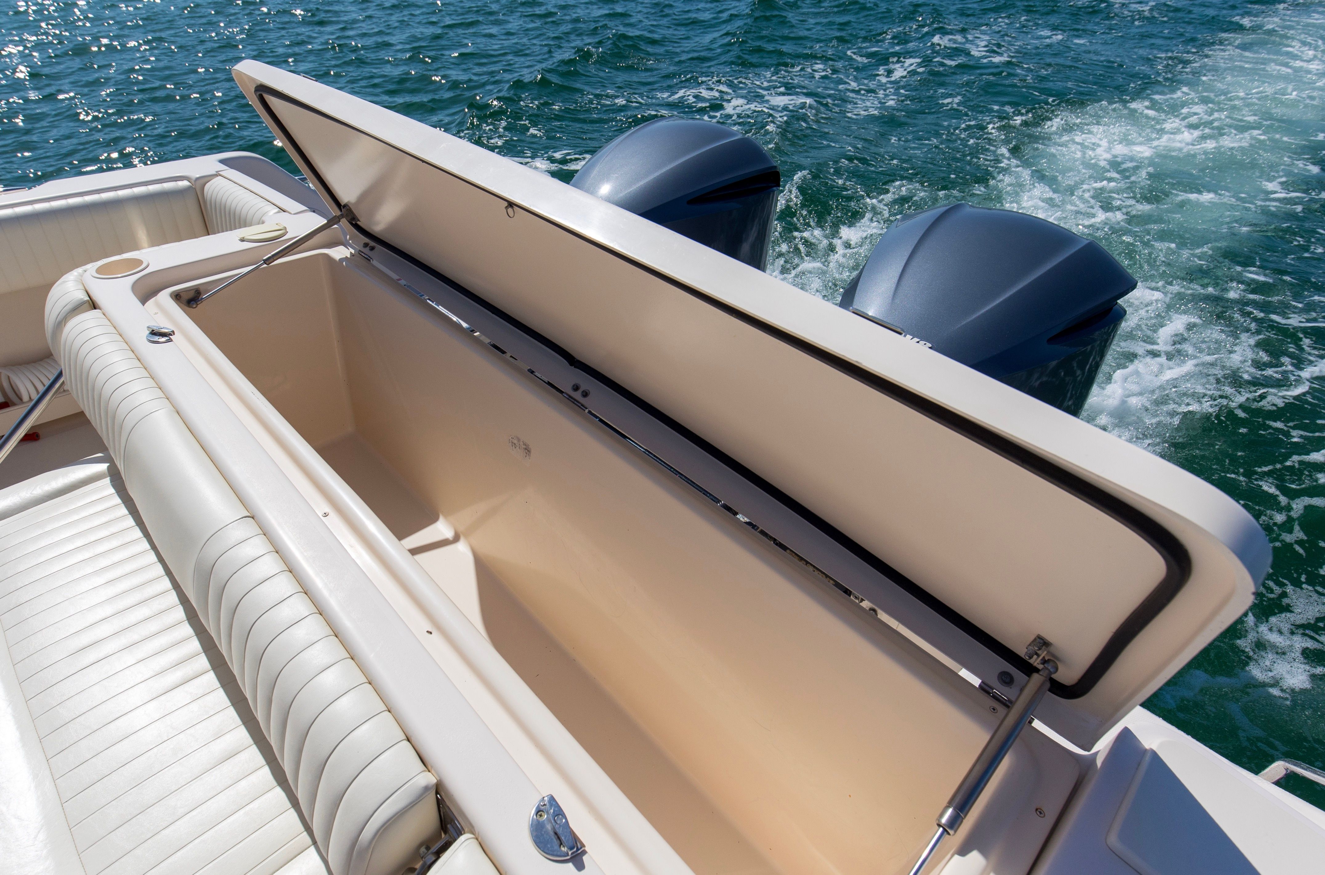 Grady-White Express 330 boat with open storage compartment on water.