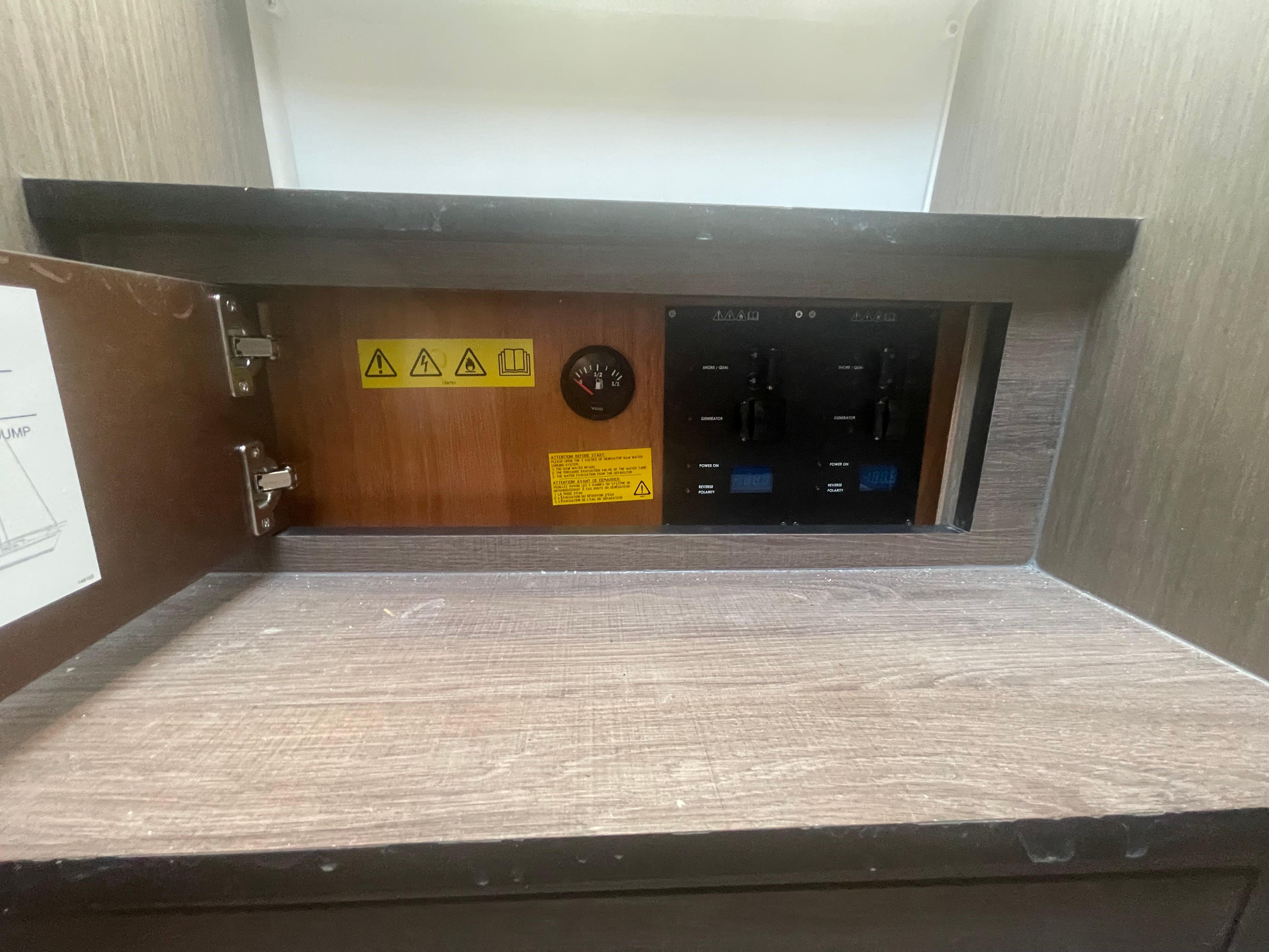 Electrical panel inside 2024 Beneteau Gran Turismo 32 yacht, featuring control switches and warning labels.