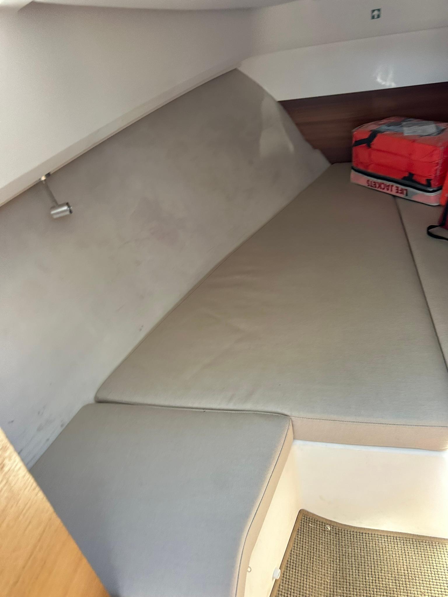 Interior cabin of 2021 Nimbus W9 boat with cushioned seating.
