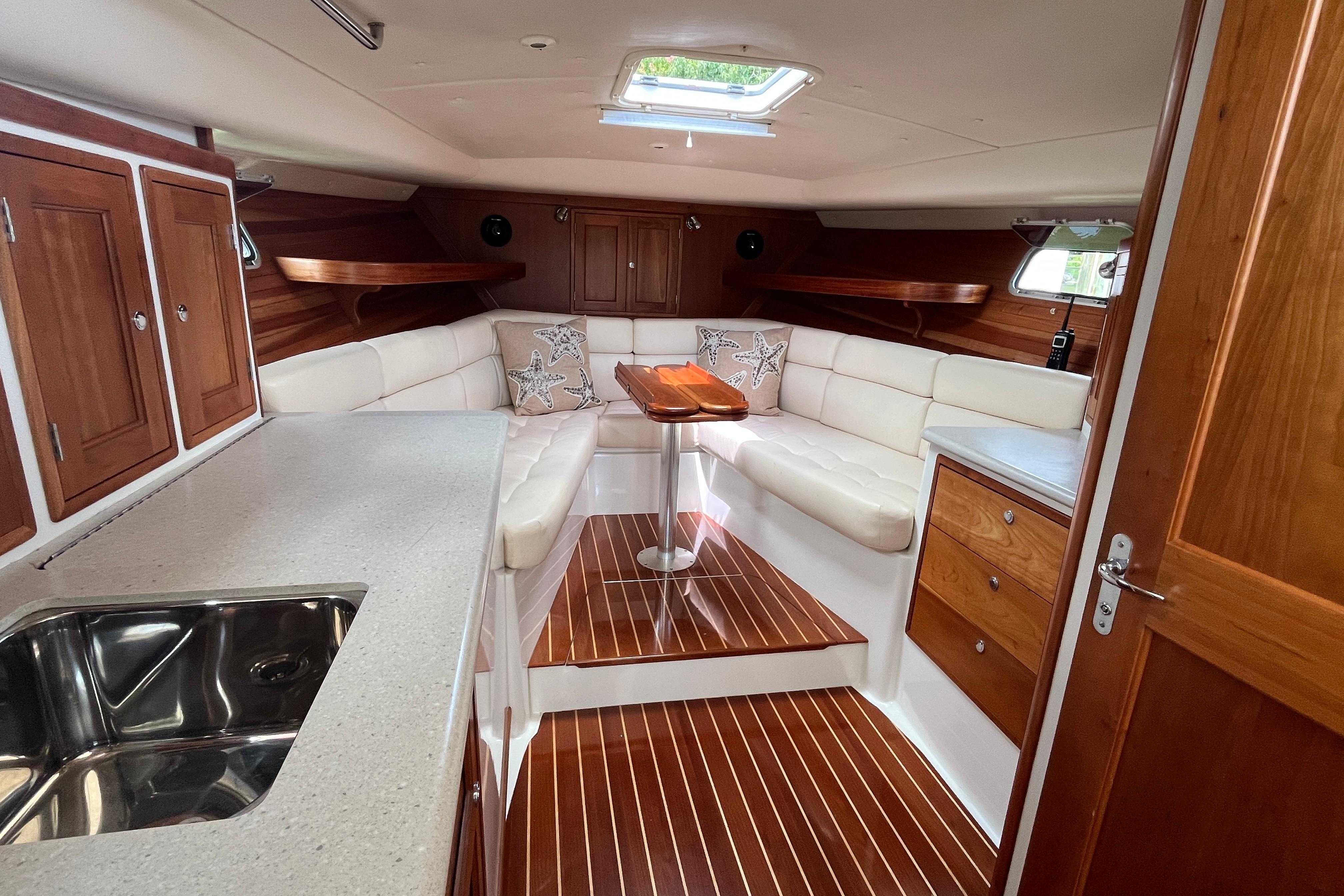 Luxurious interior of a 2006 MJM 34z yacht with elegant wood finishes and plush seating.