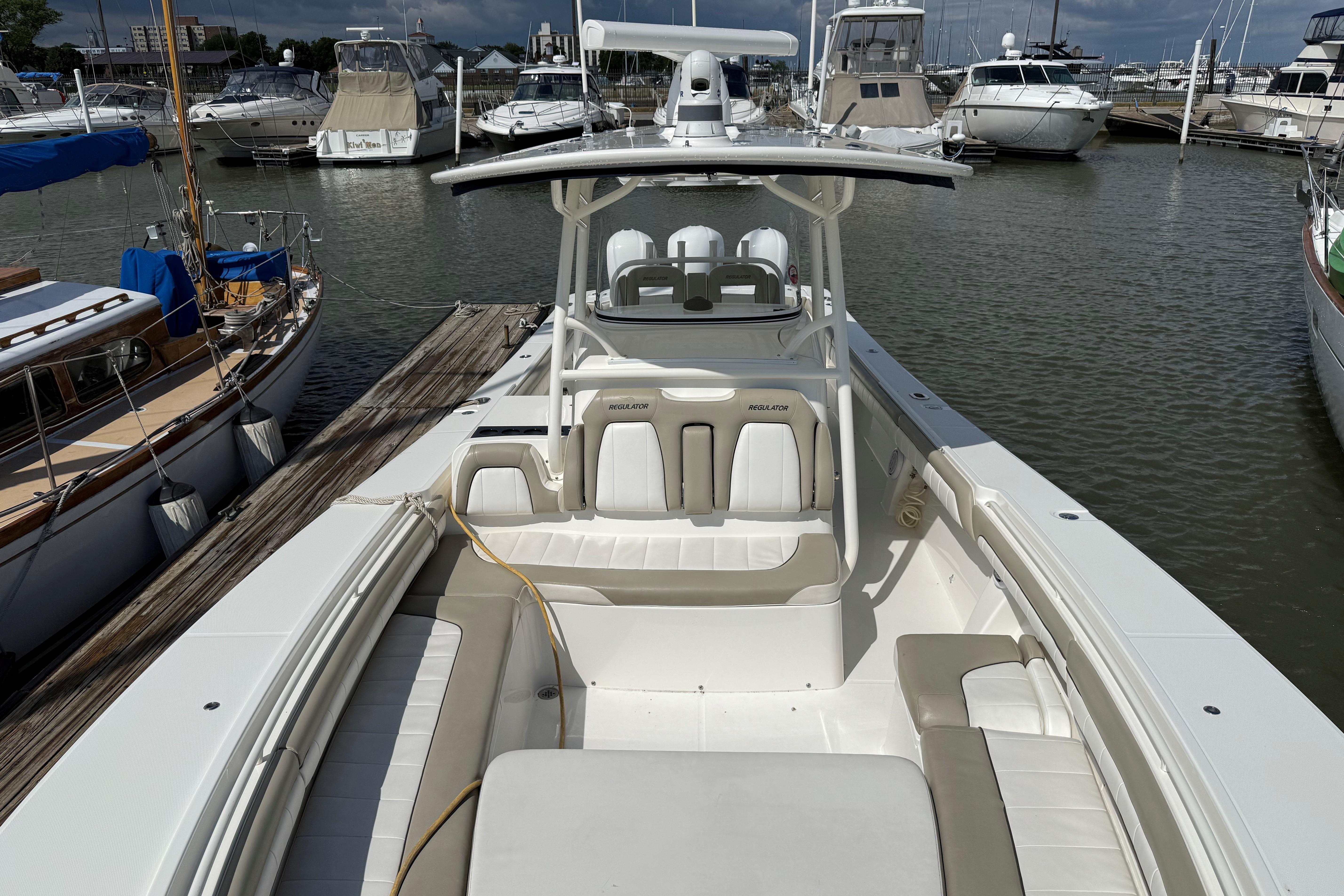 2019 Regulator 34SS boat docked at marina, surrounded by other vessels.