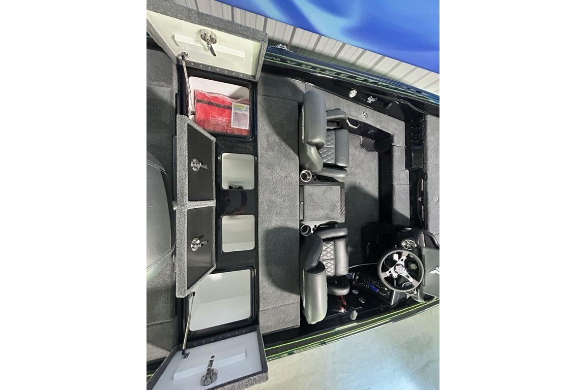 Interior view of 2026 Phoenix 819 ZXL boat with storage compartments and seating.