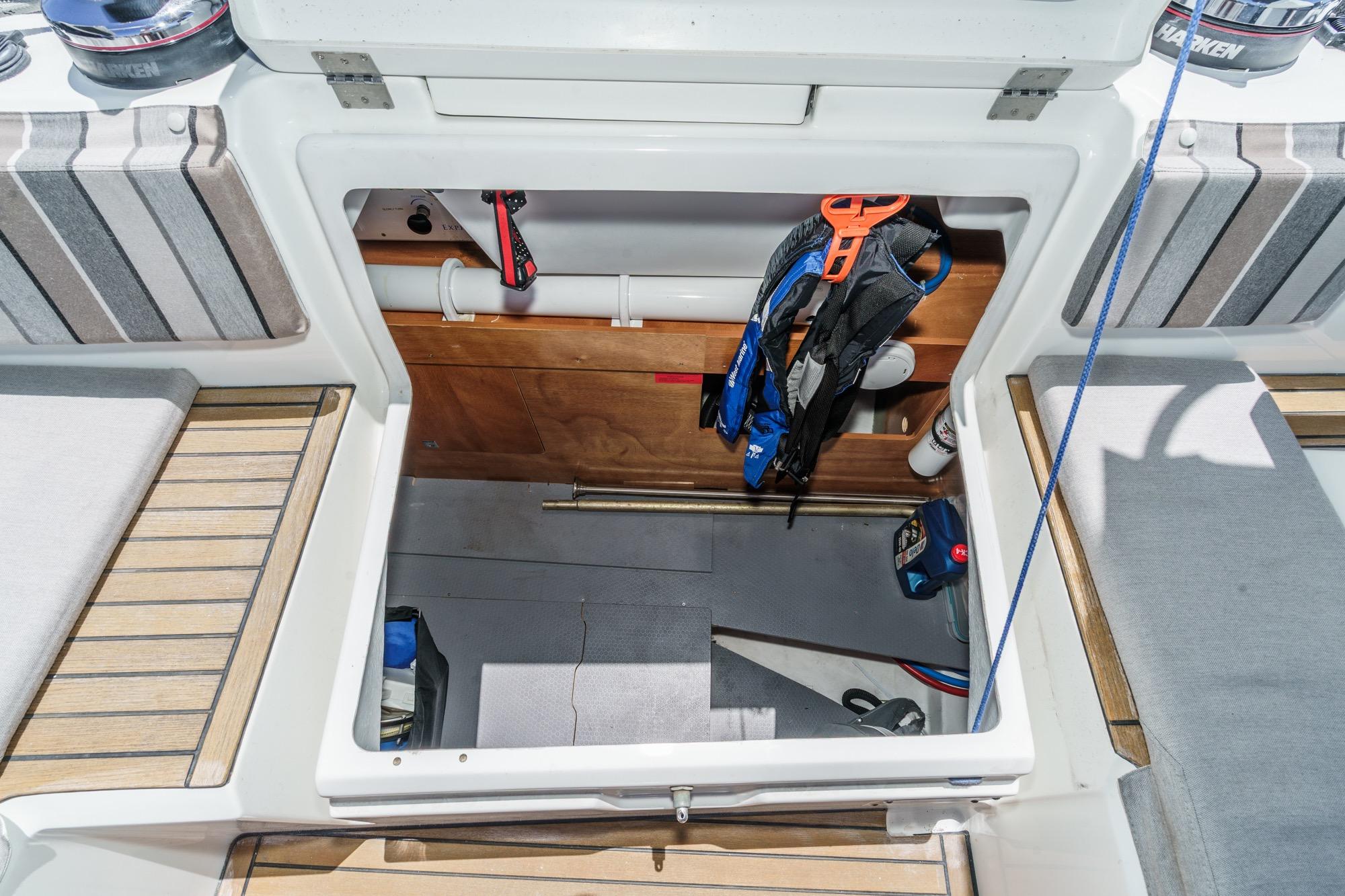 2017 Beneteau Sense 50 yacht storage compartment with safety gear and equipment.
