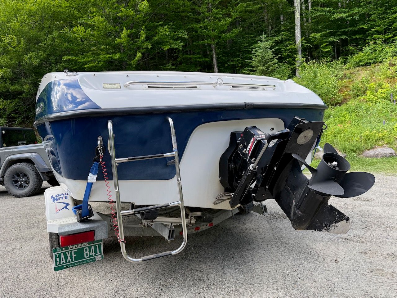 2000 Crownline 192 BR boat on trailer in wooded area.