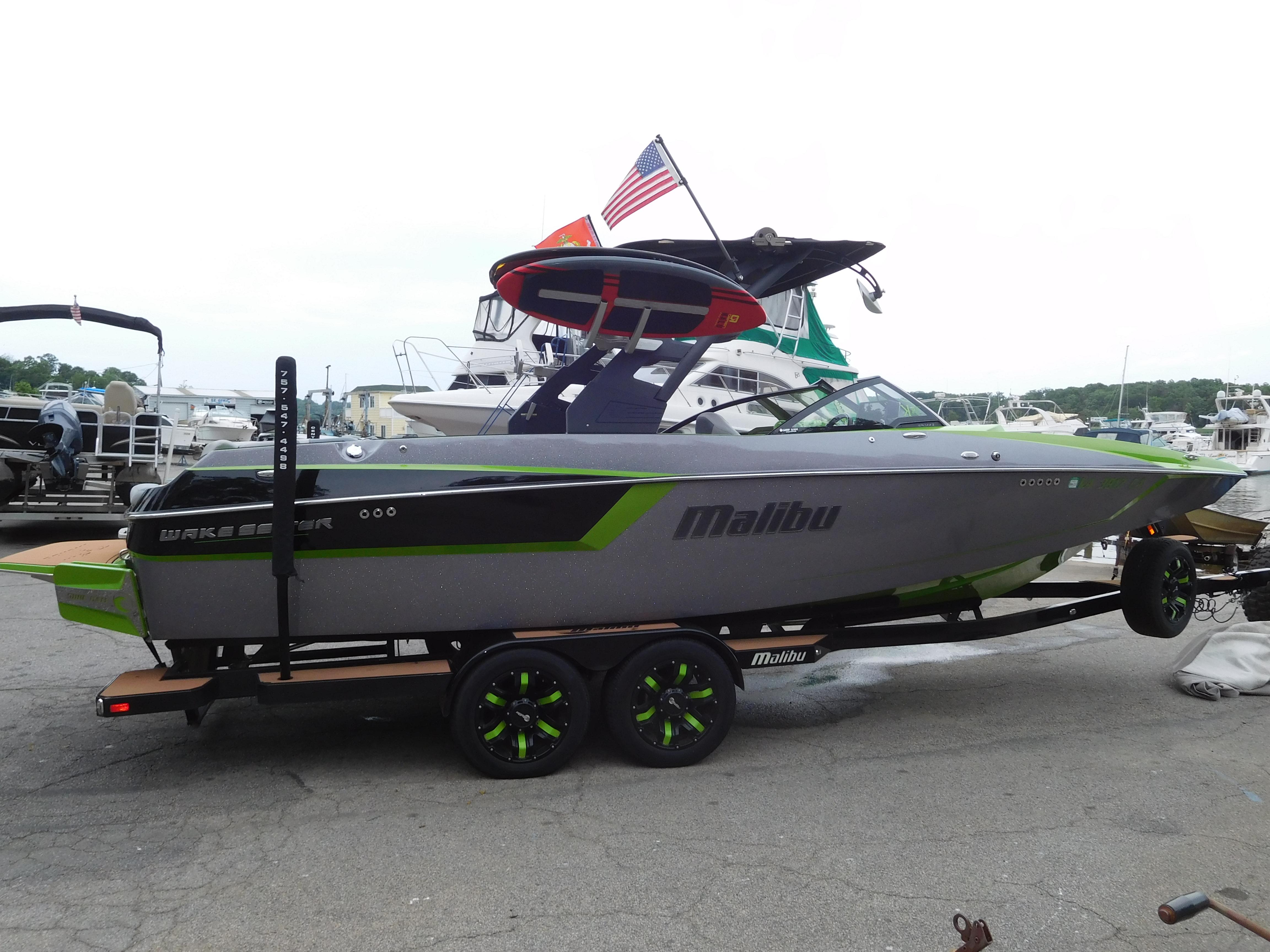2017 Malibu Wakesetter 24 MXZ boat on trailer at marina.