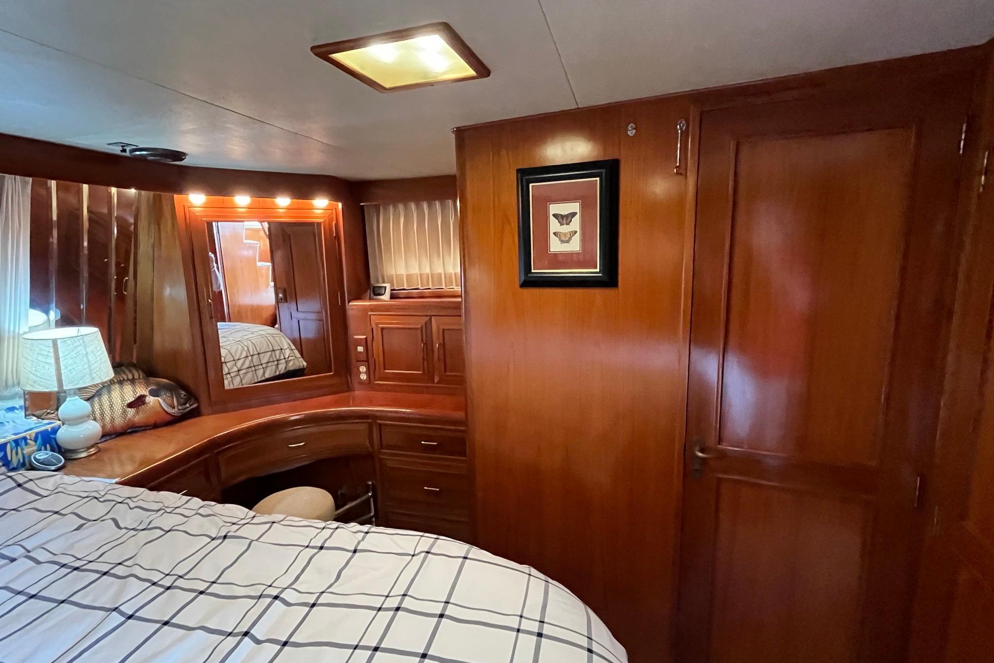 Luxurious 1989 Ocean Alexander 440 Sundeck CPMY cabin with elegant wood interior.
