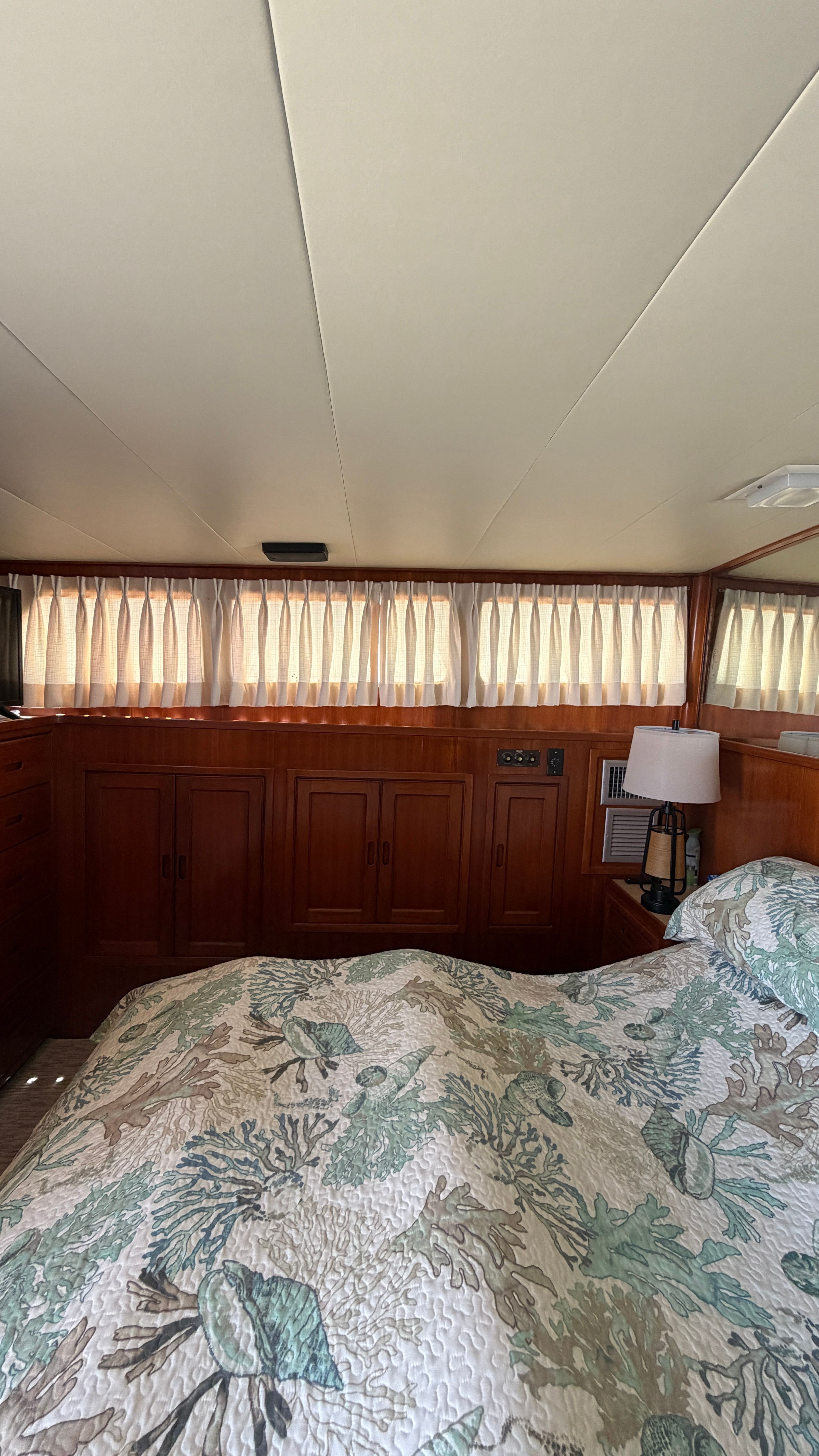 Interior of a 1966 Drake Yachtfisher with wood furnishings and bed.