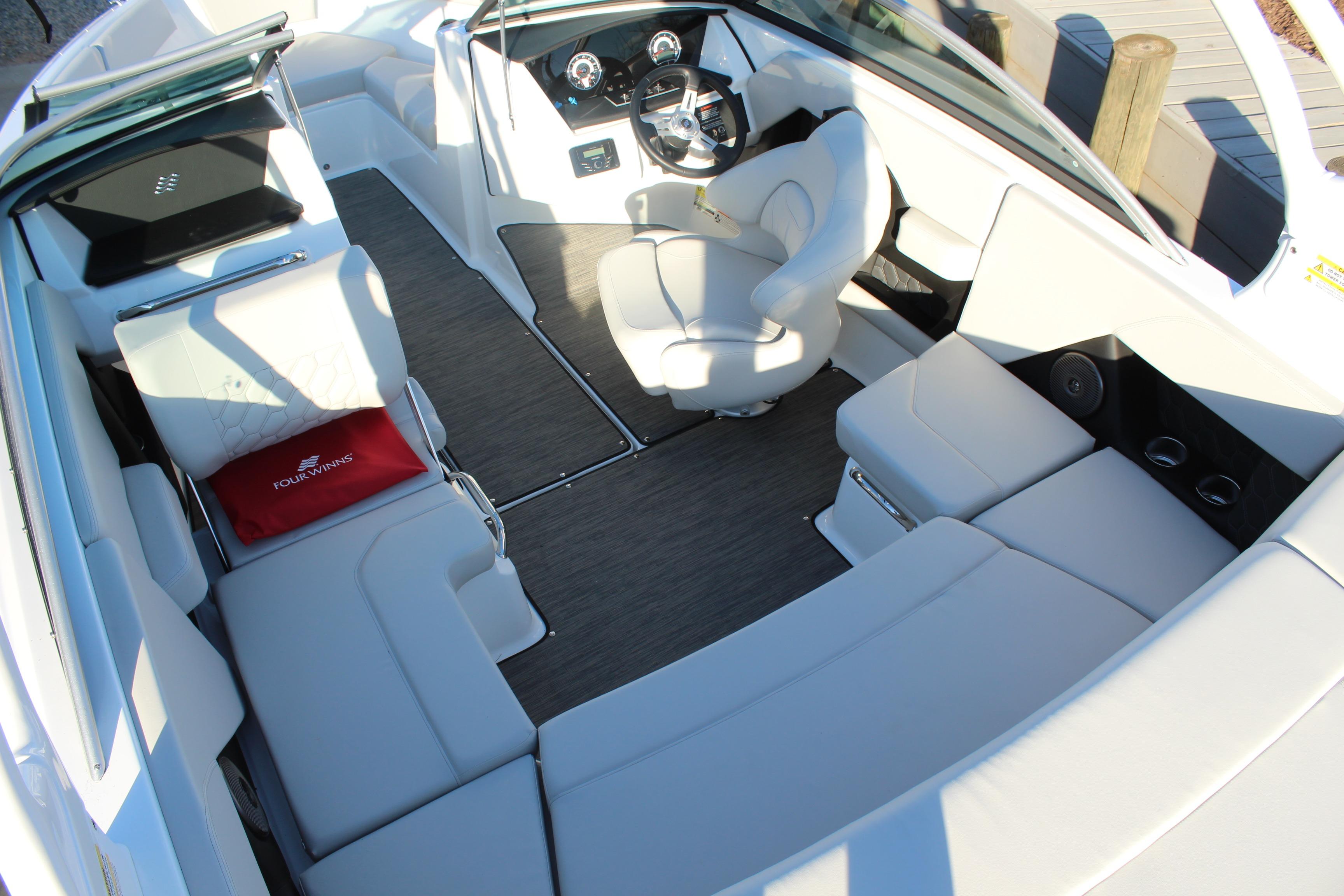 2026 Four Winns H2 Freedom boat interior with luxurious seating and modern dashboard.