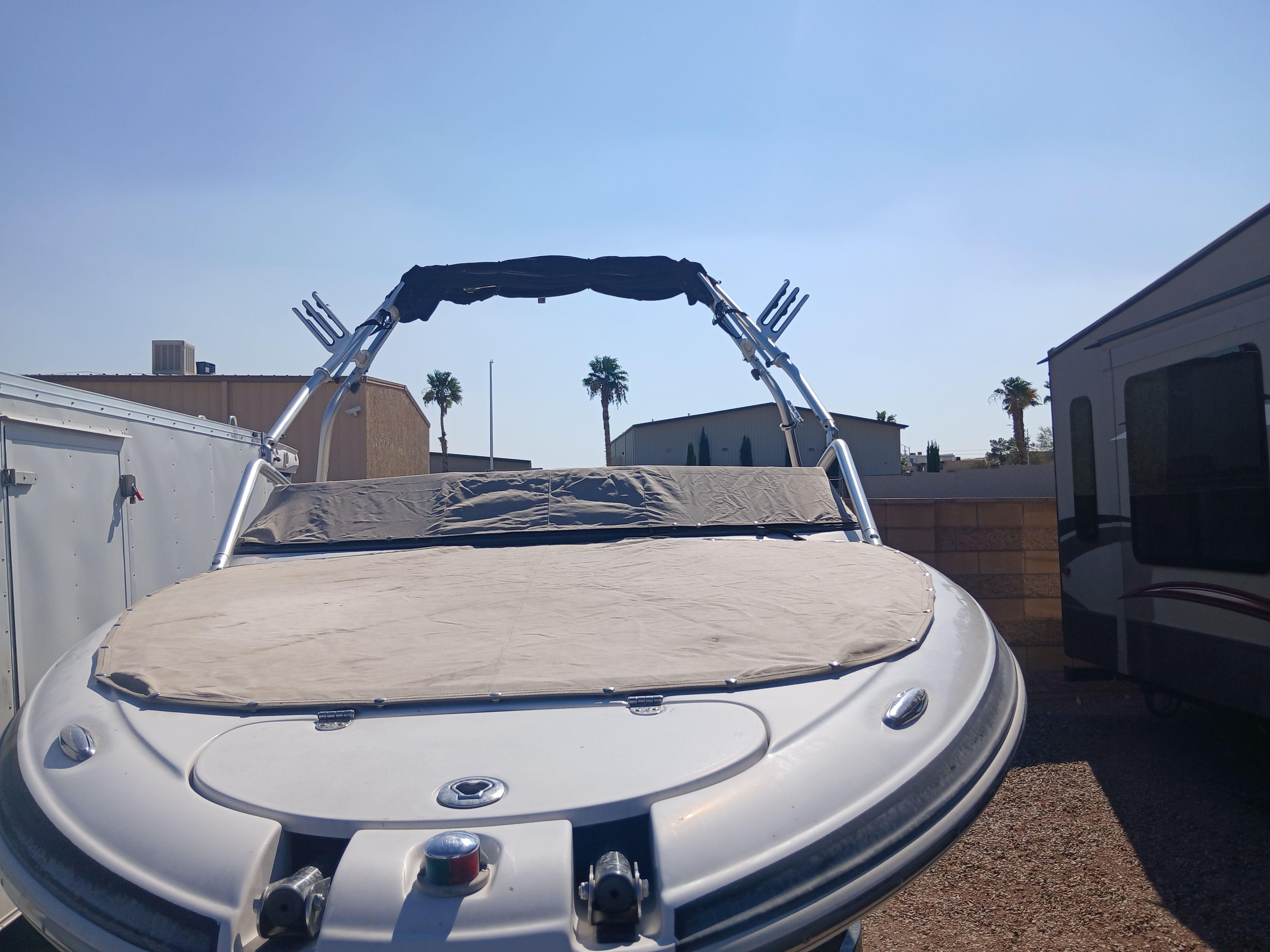 2008 Four Winns H220SS boat with cover, parked outdoors.