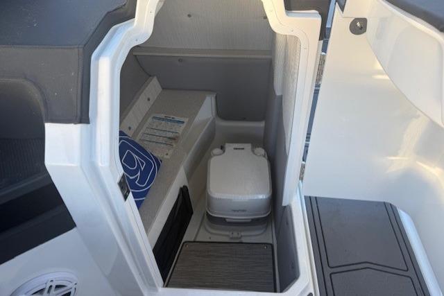 2023 Cobalt R6 Surf boat interior with compact marine toilet.