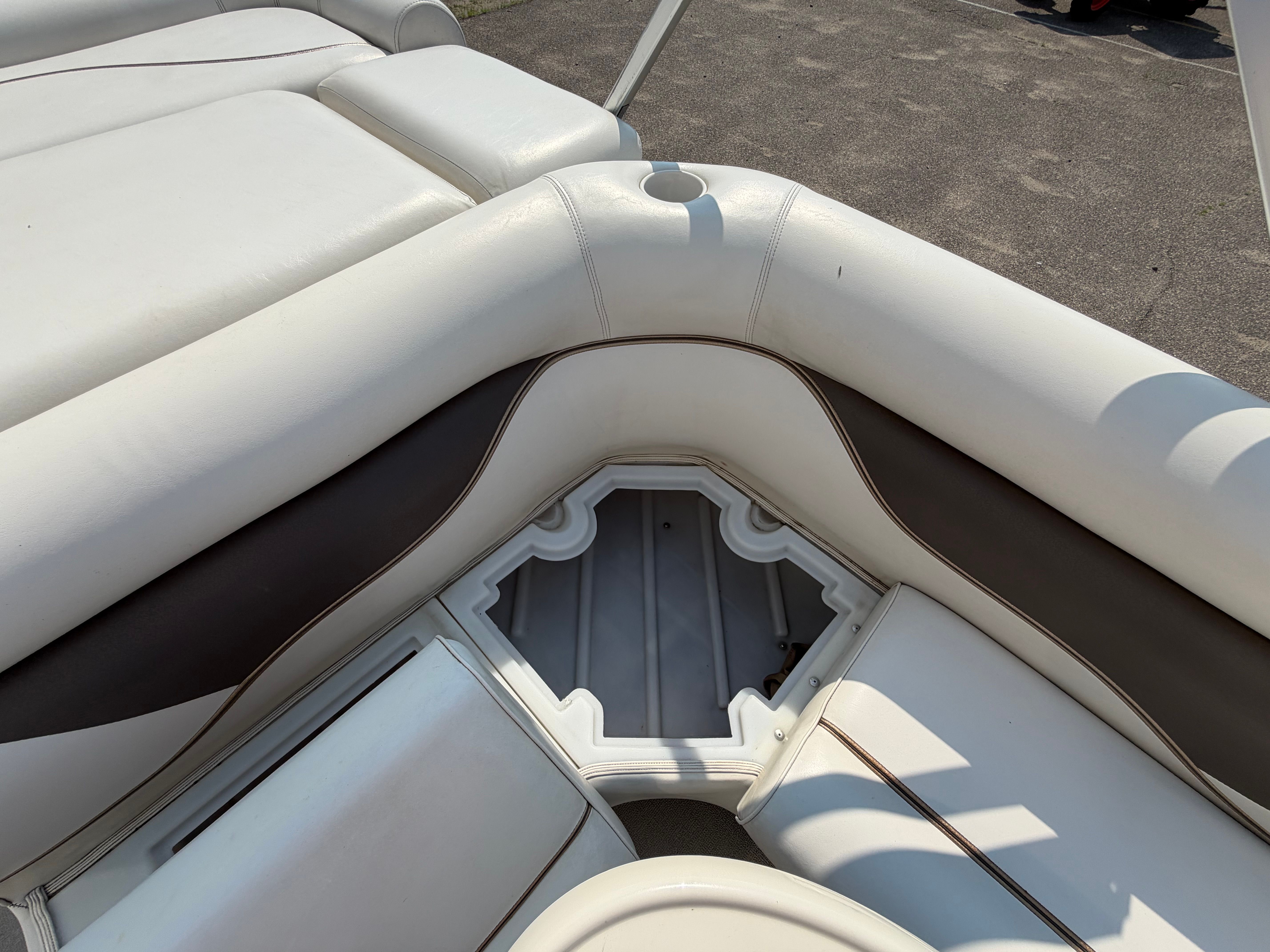 The 2007 Premier 225 Sunsation features white upholstery with brown accents and a storage compartment.