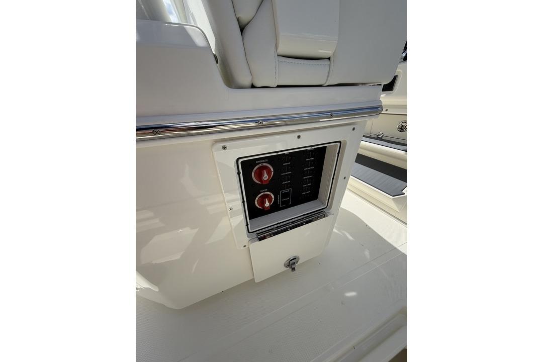 Control panel on 2026 Pathfinder 2800 Hybrid boat, featuring dual red switches.
