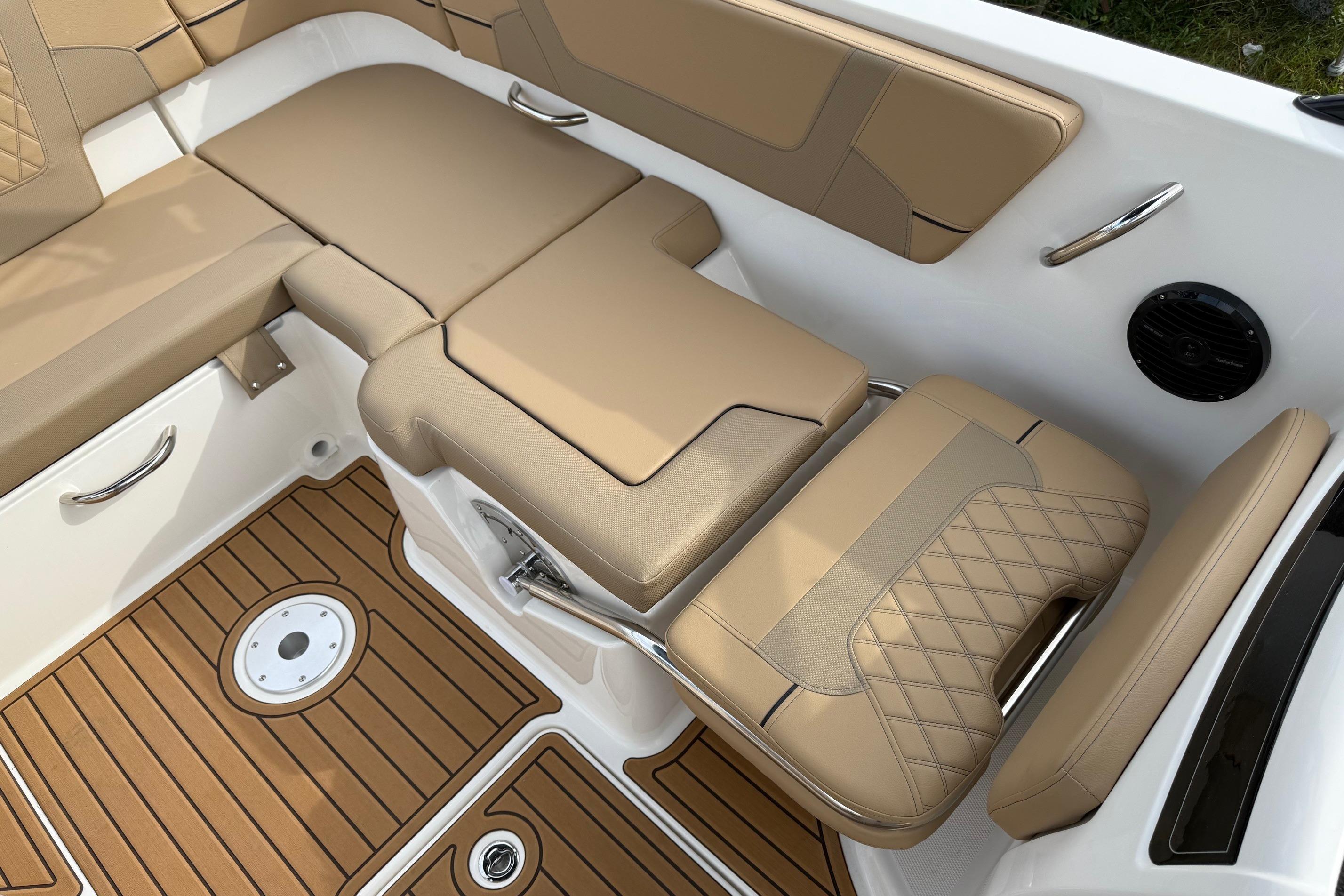 2026 Bayliner VR6 Bowrider OB interior with tan leather seating and teak-style flooring.