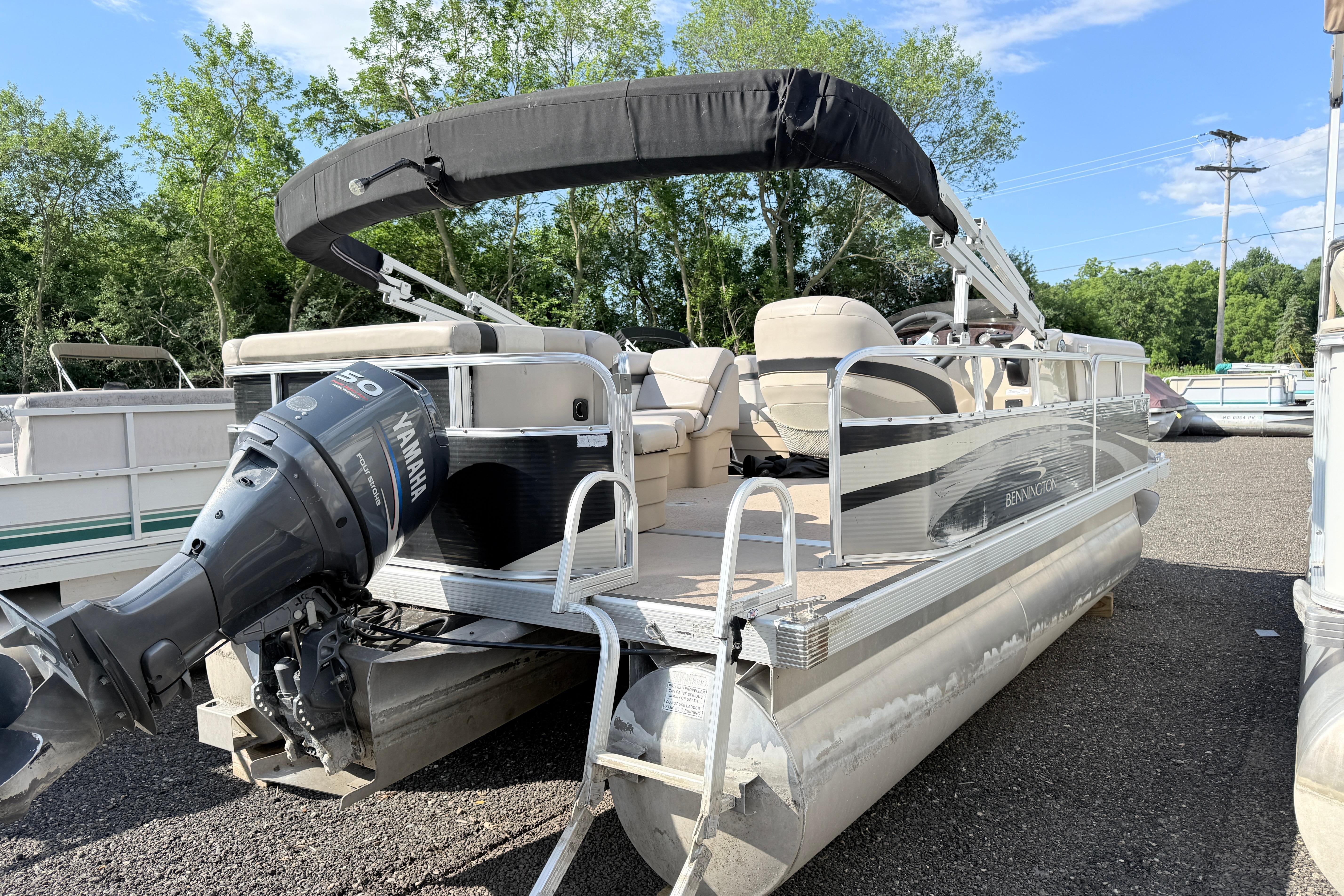 2010 Bennington 20SLi pontoon boat with Yamaha outboard motor, parked outdoors.